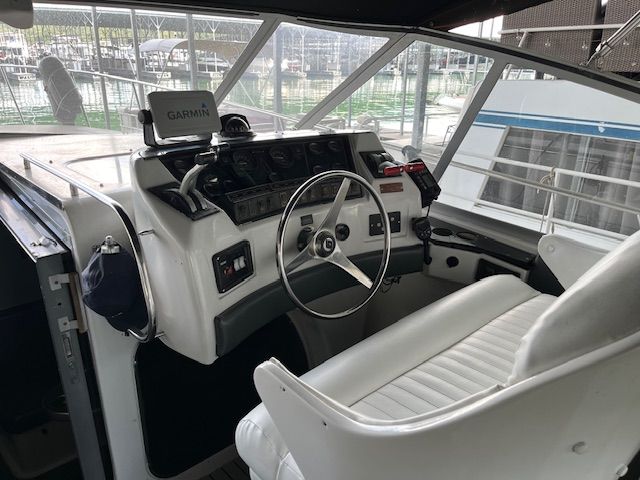 Interior of a 1989 Trojan 370 Express with white helm and Garmin device.