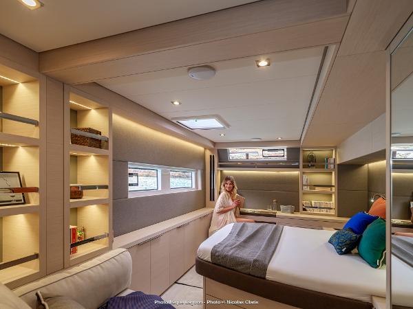 Luxurious interior of 2025 Lagoon 55 yacht with modern design and cozy bedroom.