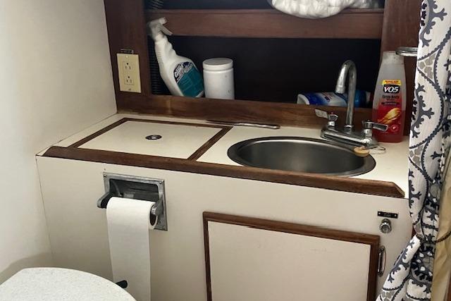 1979 Pearson 365 Ketch bathroom with sink, storage, and toiletries.