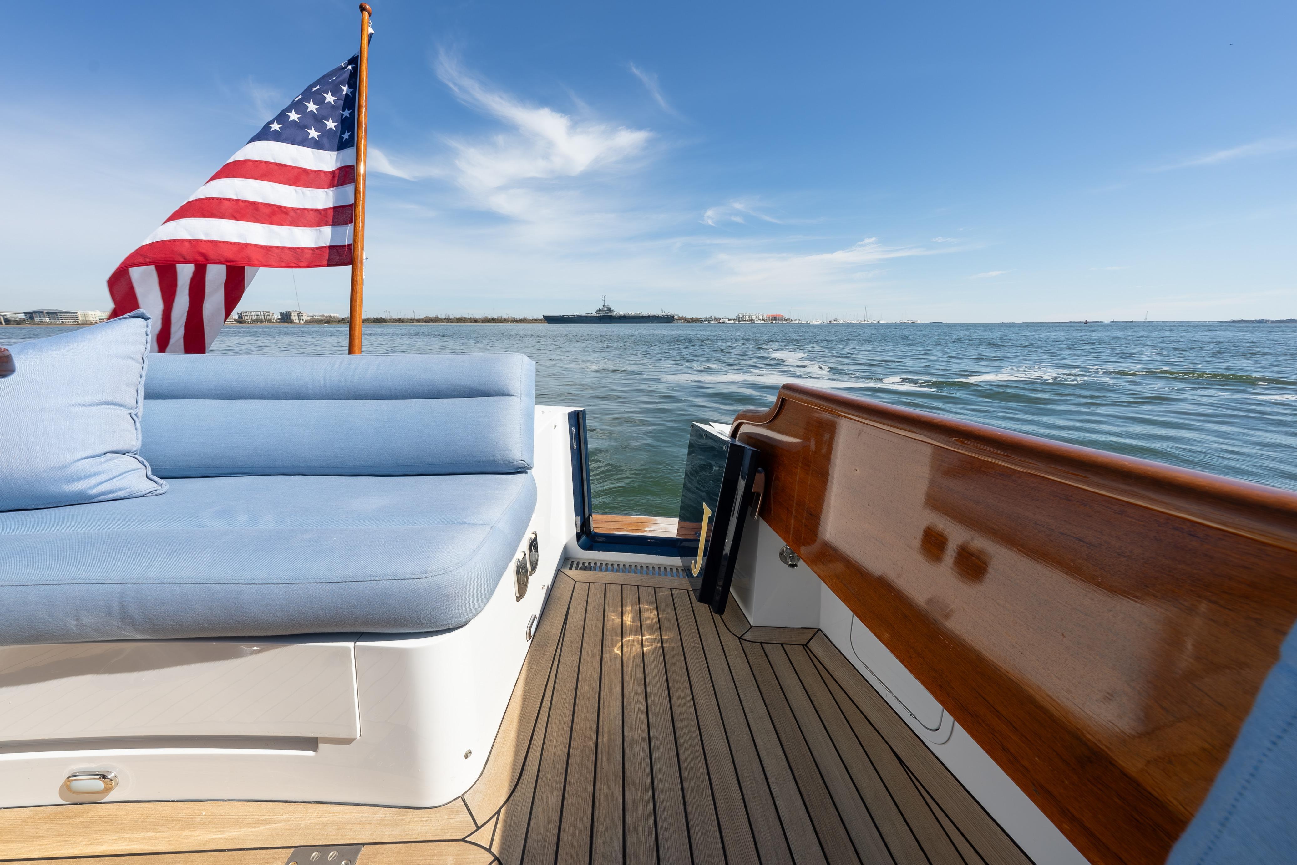 2015 Hinckley Talaria 43 yacht with American flag, cruising on open water.