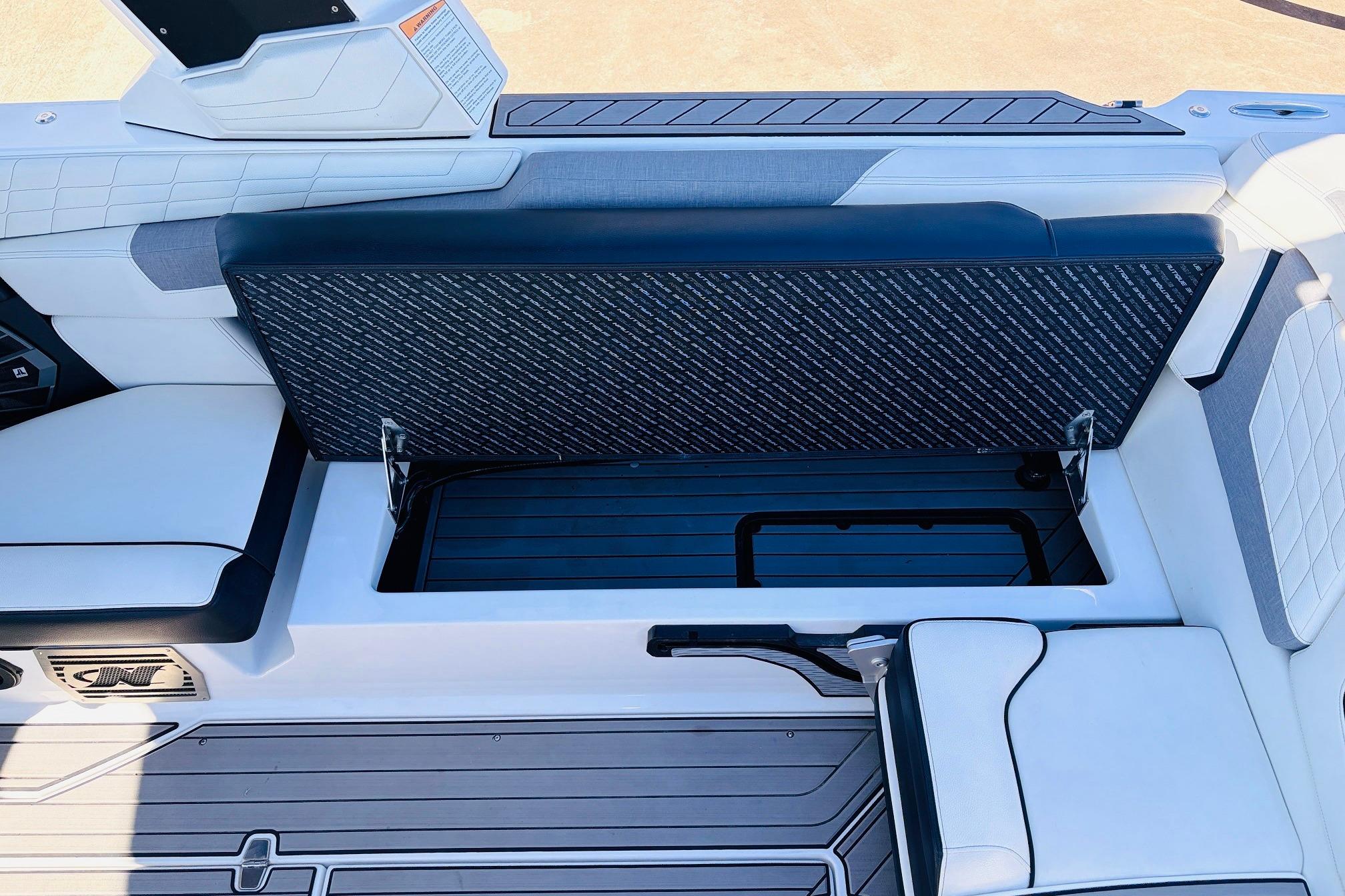 2023 Nautique Super Air Nautique G25 interior storage compartment with sleek seating design.