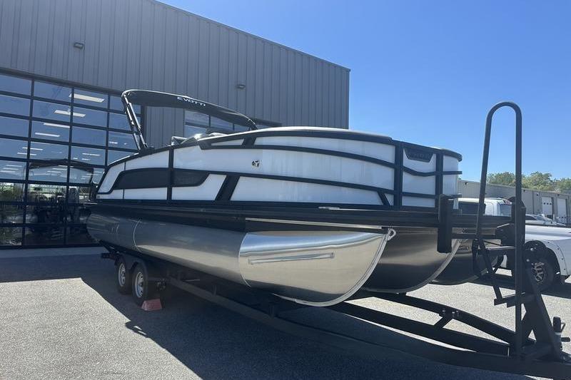 2026 Evotti 523QL pontoon boat on trailer outside a modern building.