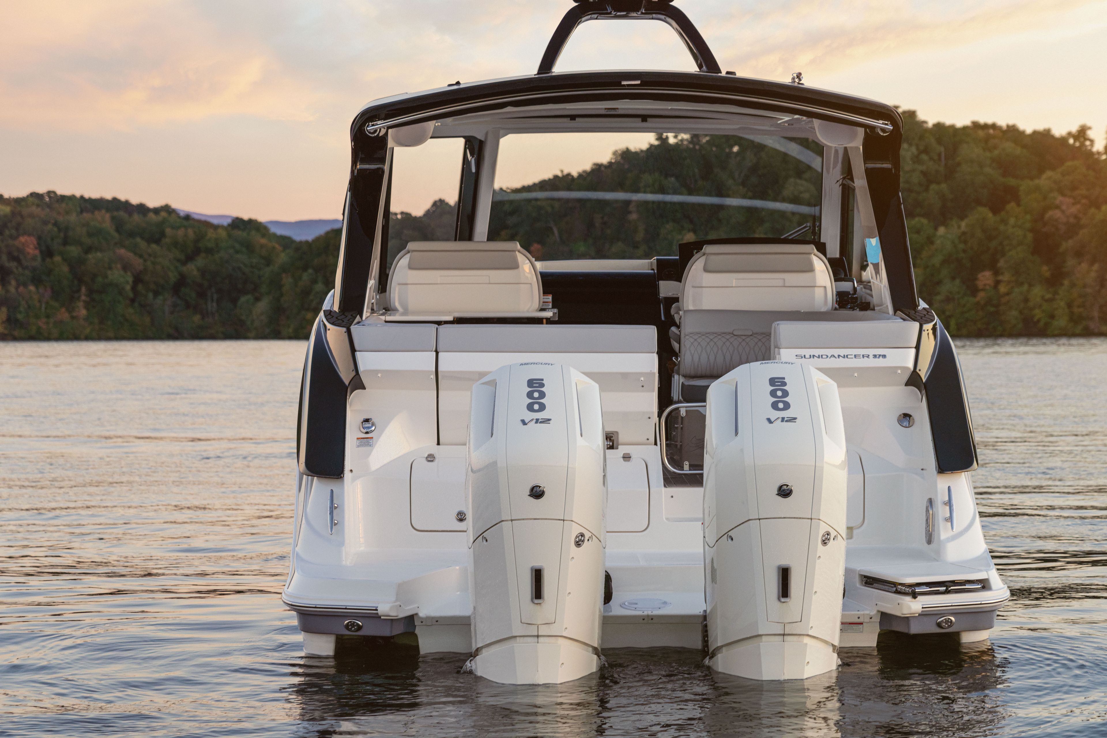 The image shows a Sea Ray Sundancer 370 Outboard boat on calm water.