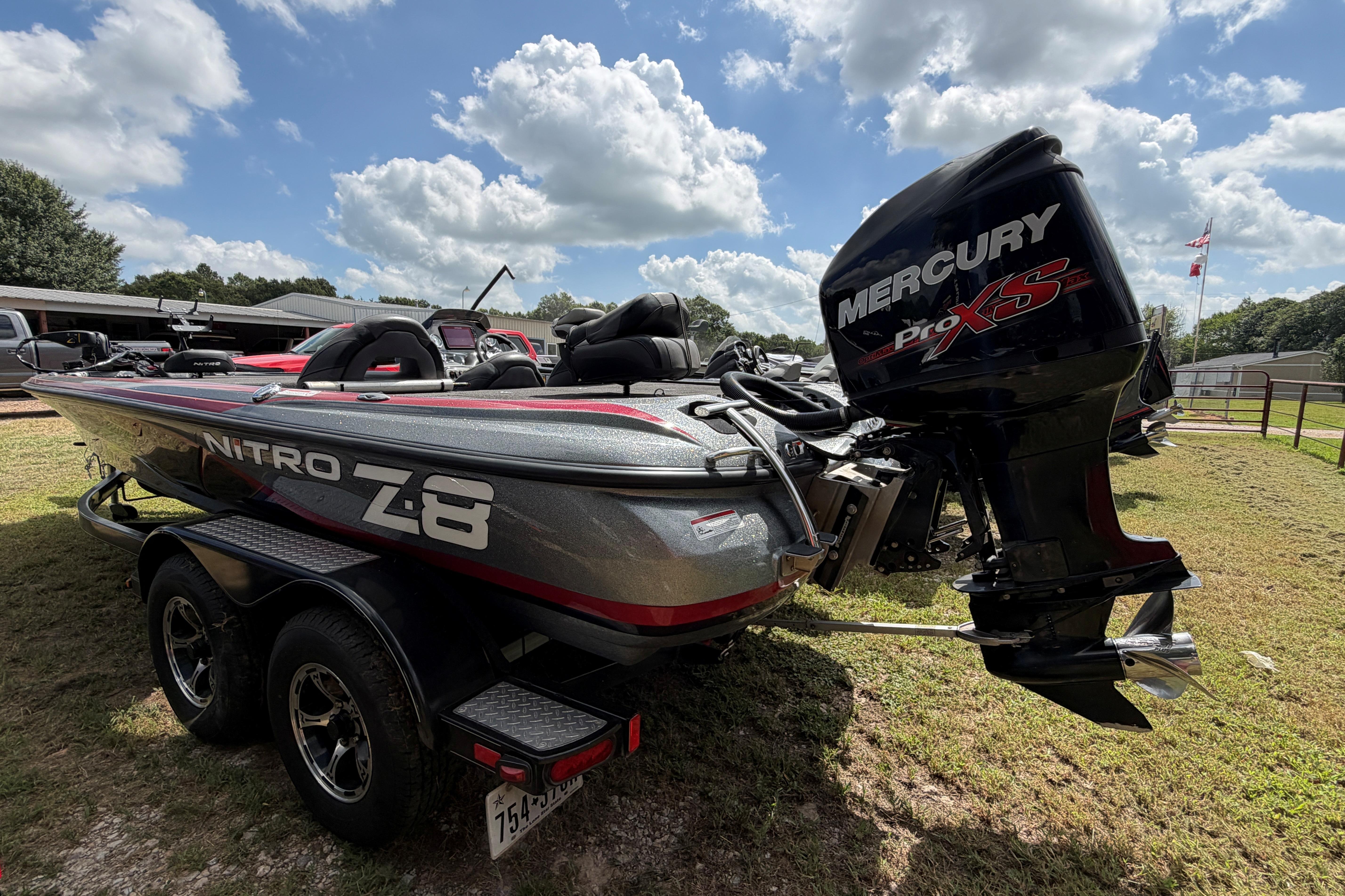 2015 Nitro Z-8 boat with Mercury Pro XS engine on a grassy area under a cloudy sky.
