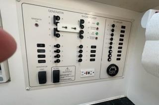 Control panel of a 2000 Rinker Fiesta Vee 310 boat with switches and indicators.