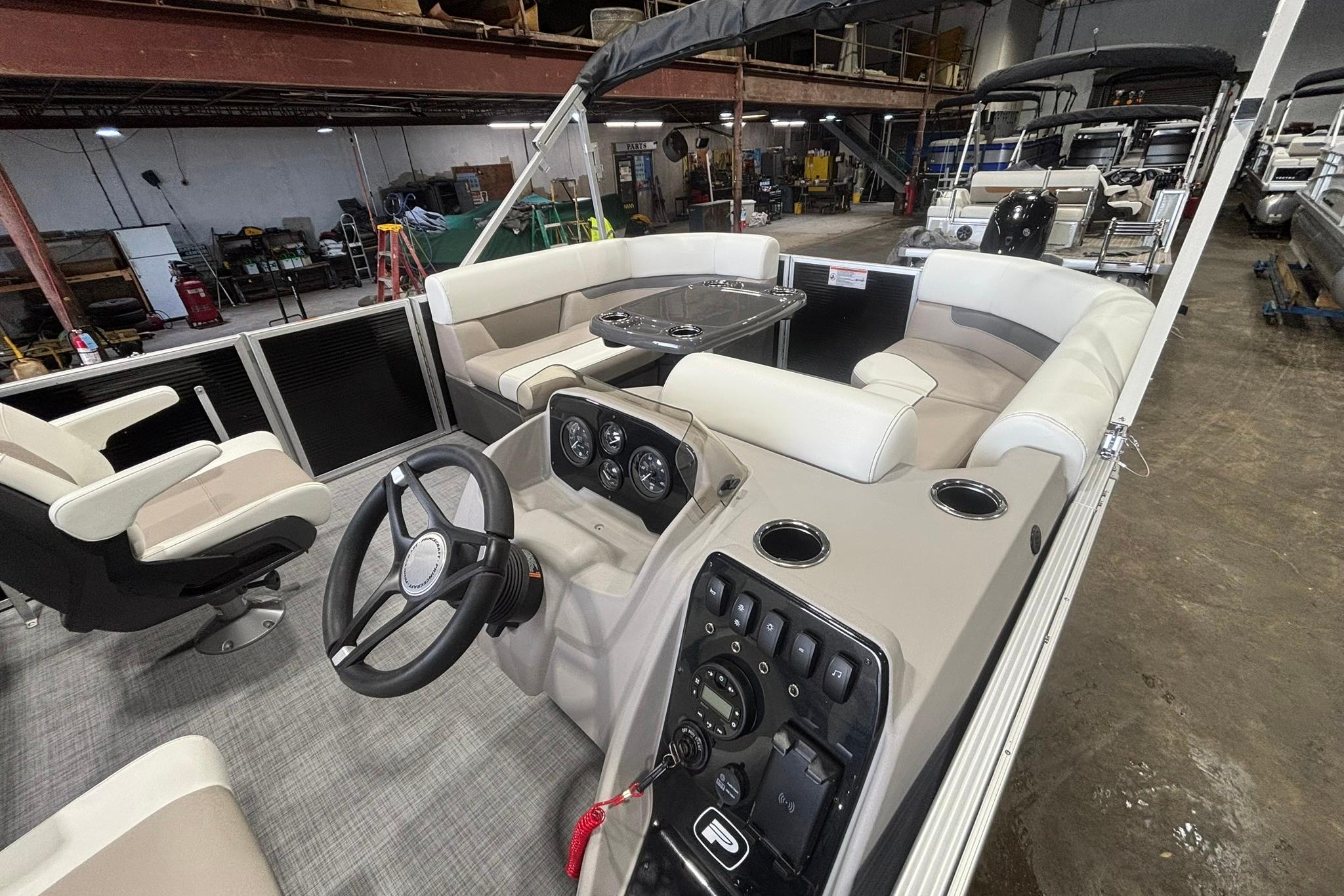 2025 Princecraft Vectra 21 RL pontoon boat interior with steering console and seating.