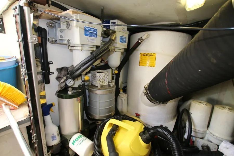 Engine room of a 2001 Princess 61 yacht with various mechanical components.