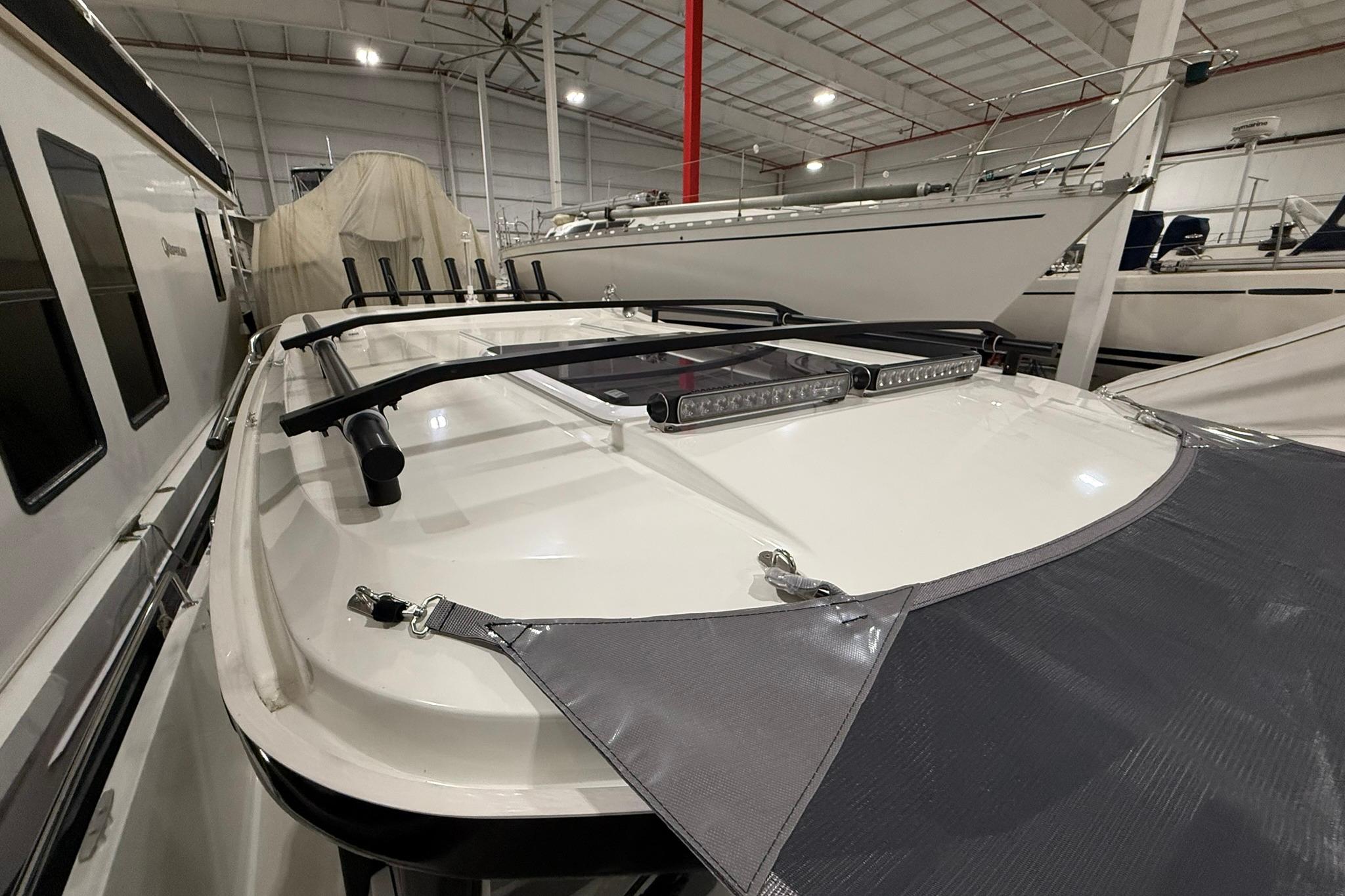 2024 Jeanneau NC Sport 795 Series 2 boat in indoor storage, showcasing roof details.