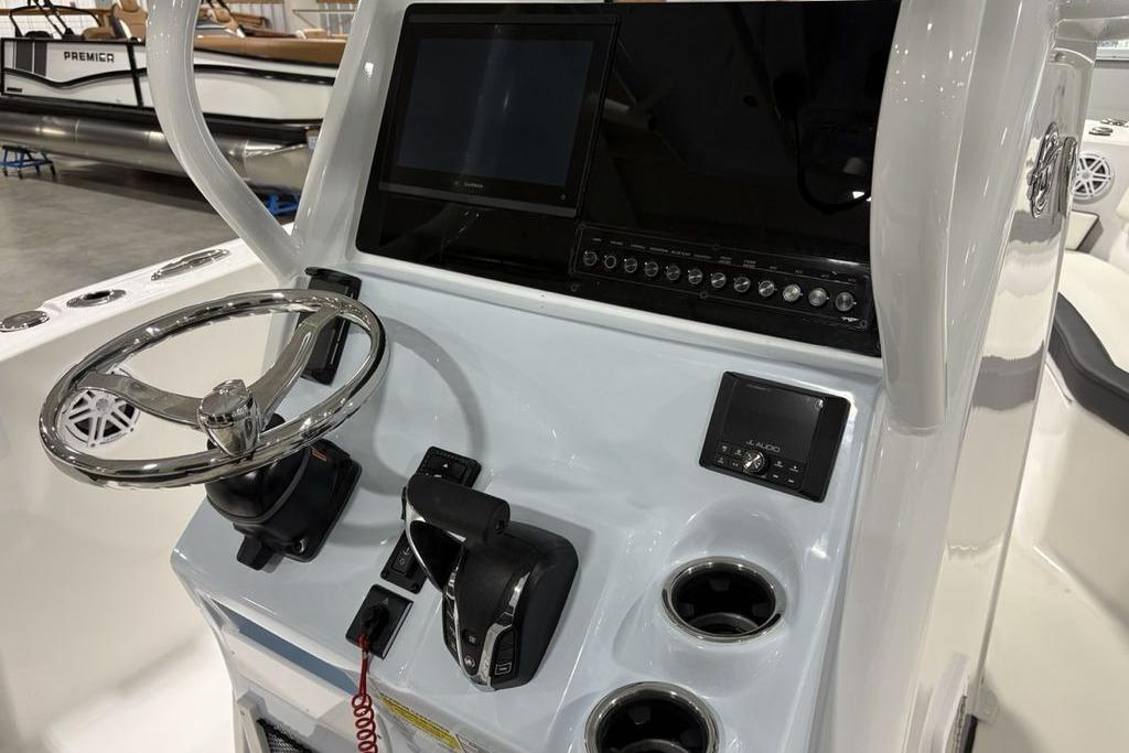 2026 Tidewater 232 CC Adventure boat console with steering wheel and electronic controls.