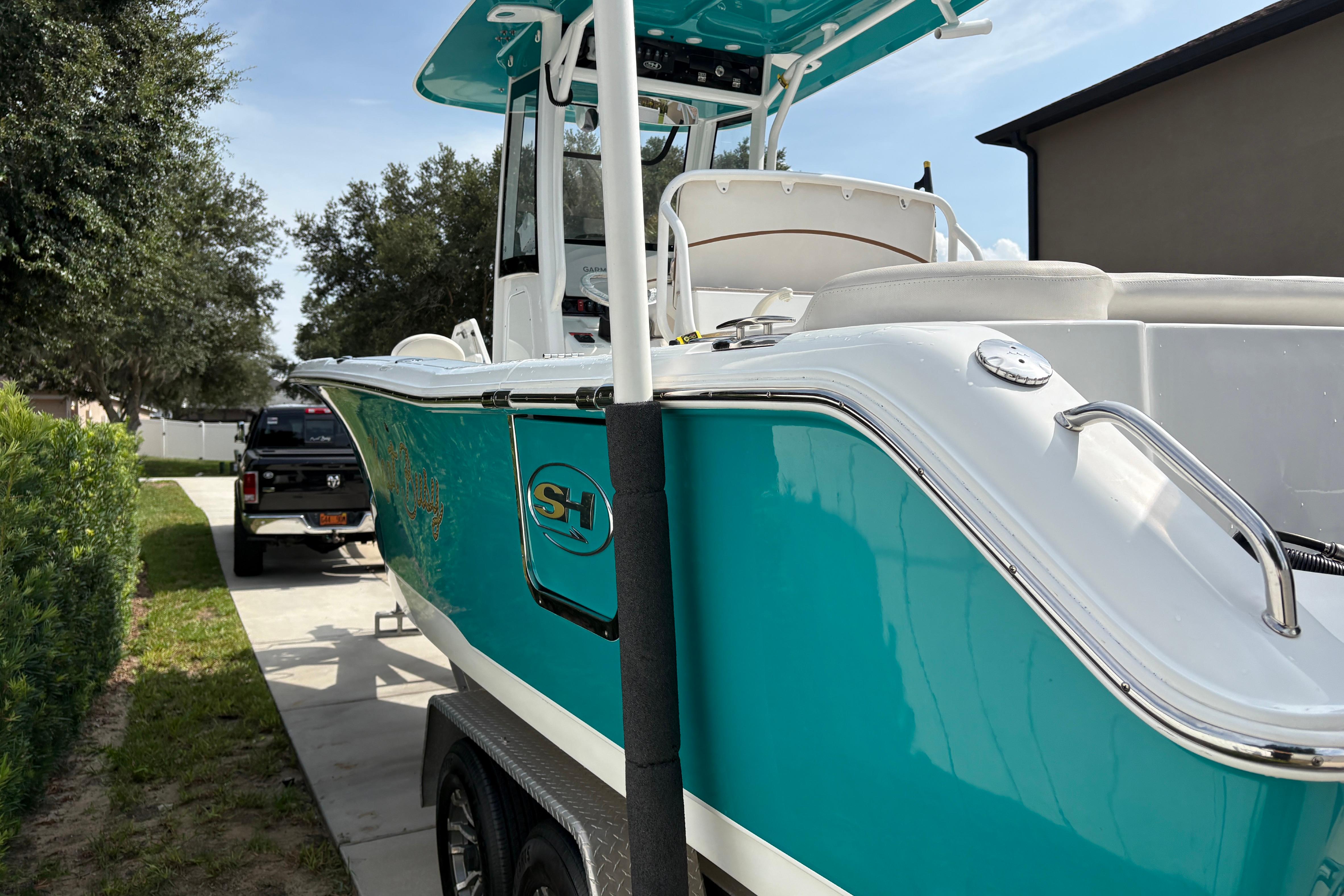 2021 Sea Hunt Ultra 265 SE boat on trailer, parked outdoors.