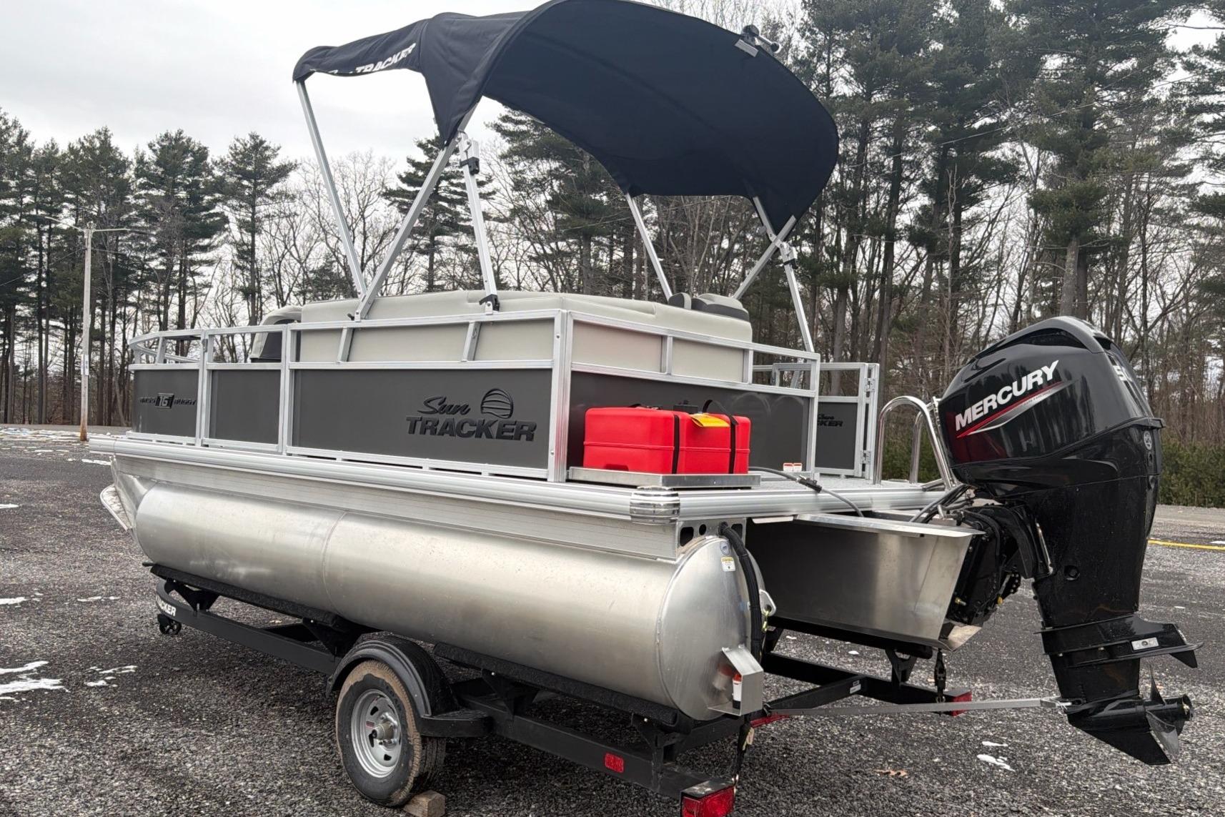 2026 Sun Tracker Bass Buggy 16 XL Select pontoon boat with Mercury outboard motor.