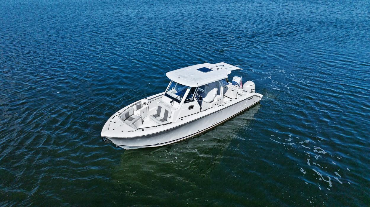 2021 Pursuit S 328 Sport boat cruising on open water.