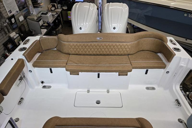 2026 Sea Hunt Ultra 275 Coffin Box boat interior with tan seating and dual engines.