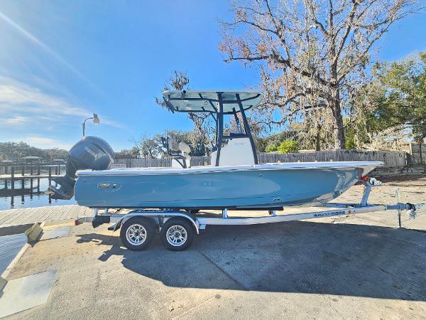 2026 Sea Hunt BX 22 BR boat on trailer, parked near a dock under clear blue sky.