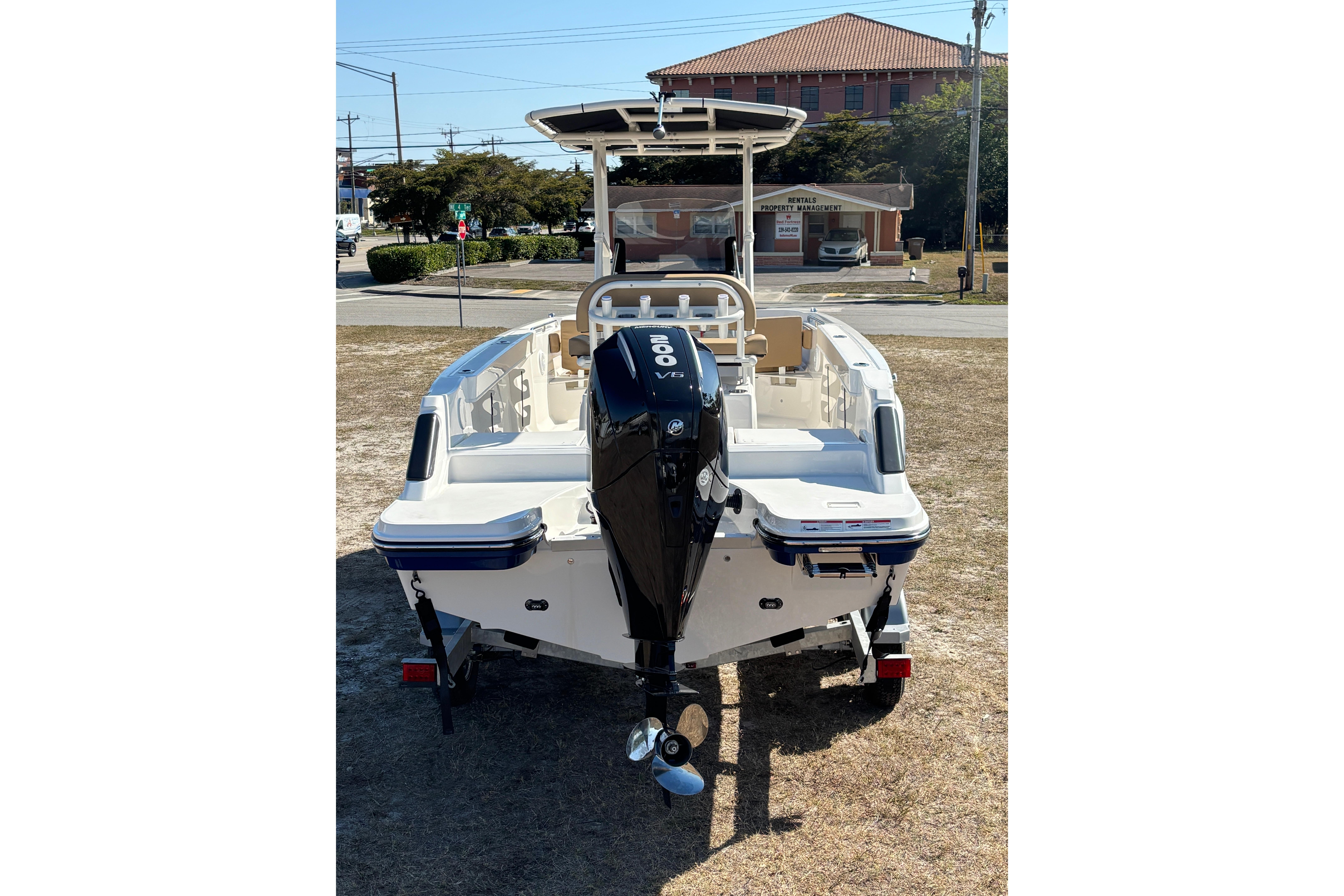 2026 Bayliner Trophy T22CC boat with outboard motor, parked on grass.