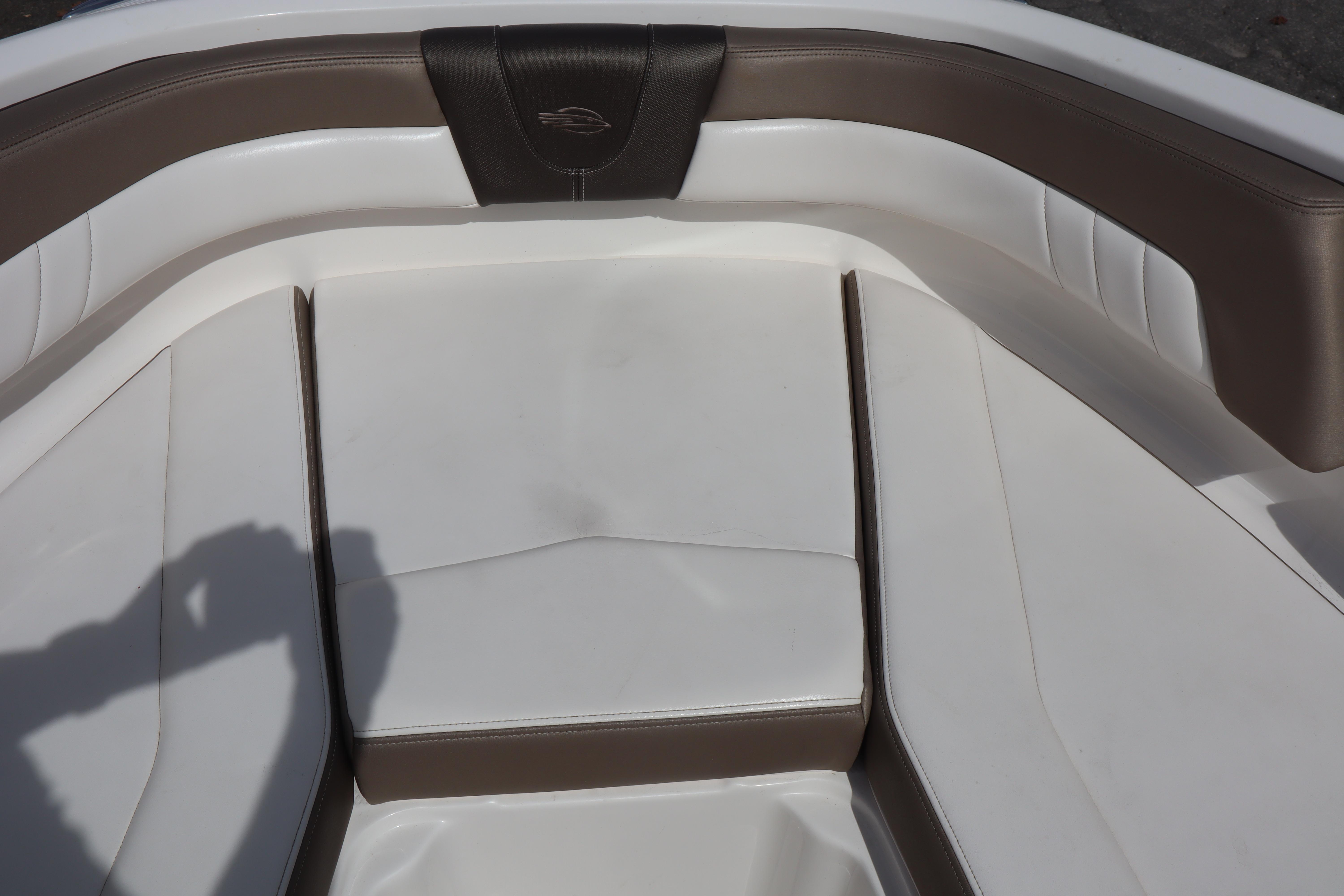 2021 Chaparral 21 SSi boat interior with white and brown cushioned seating.