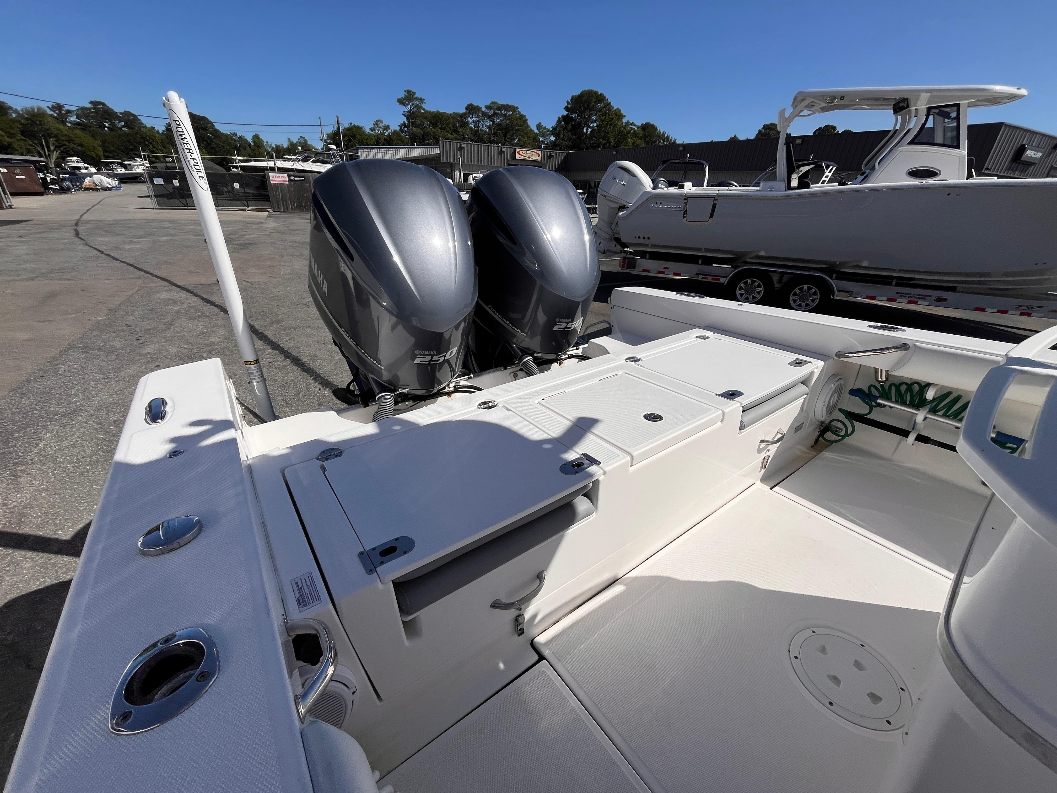 2017 Everglades 273 Center Console boat with dual Yamaha engines, docked outdoors.