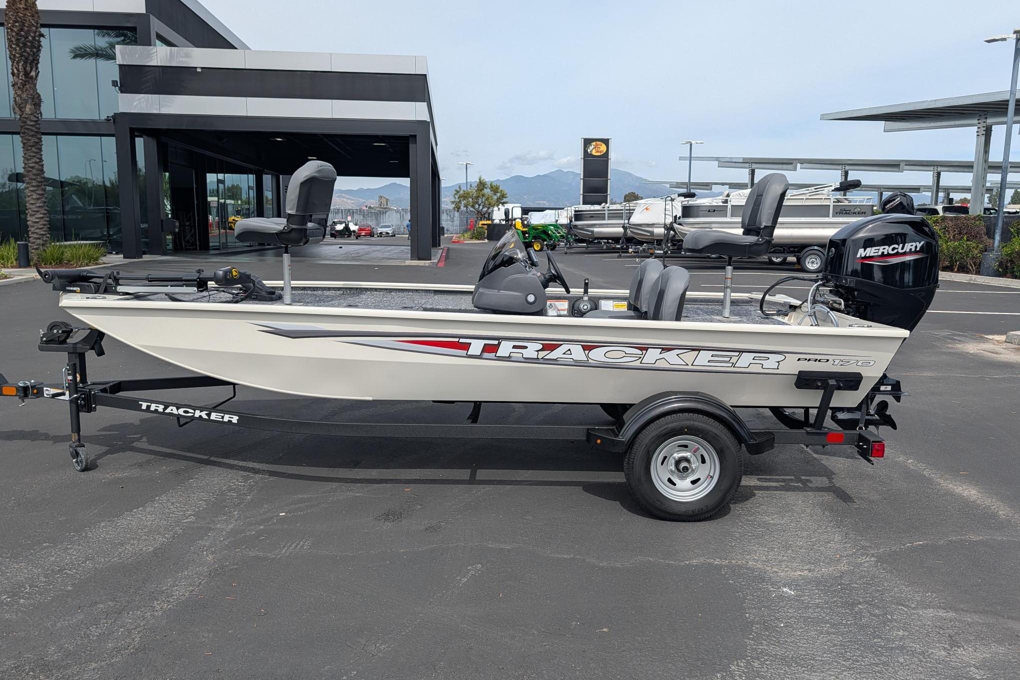 2026 Tracker Pro 170 boat with Mercury engine on trailer, parked outdoors.