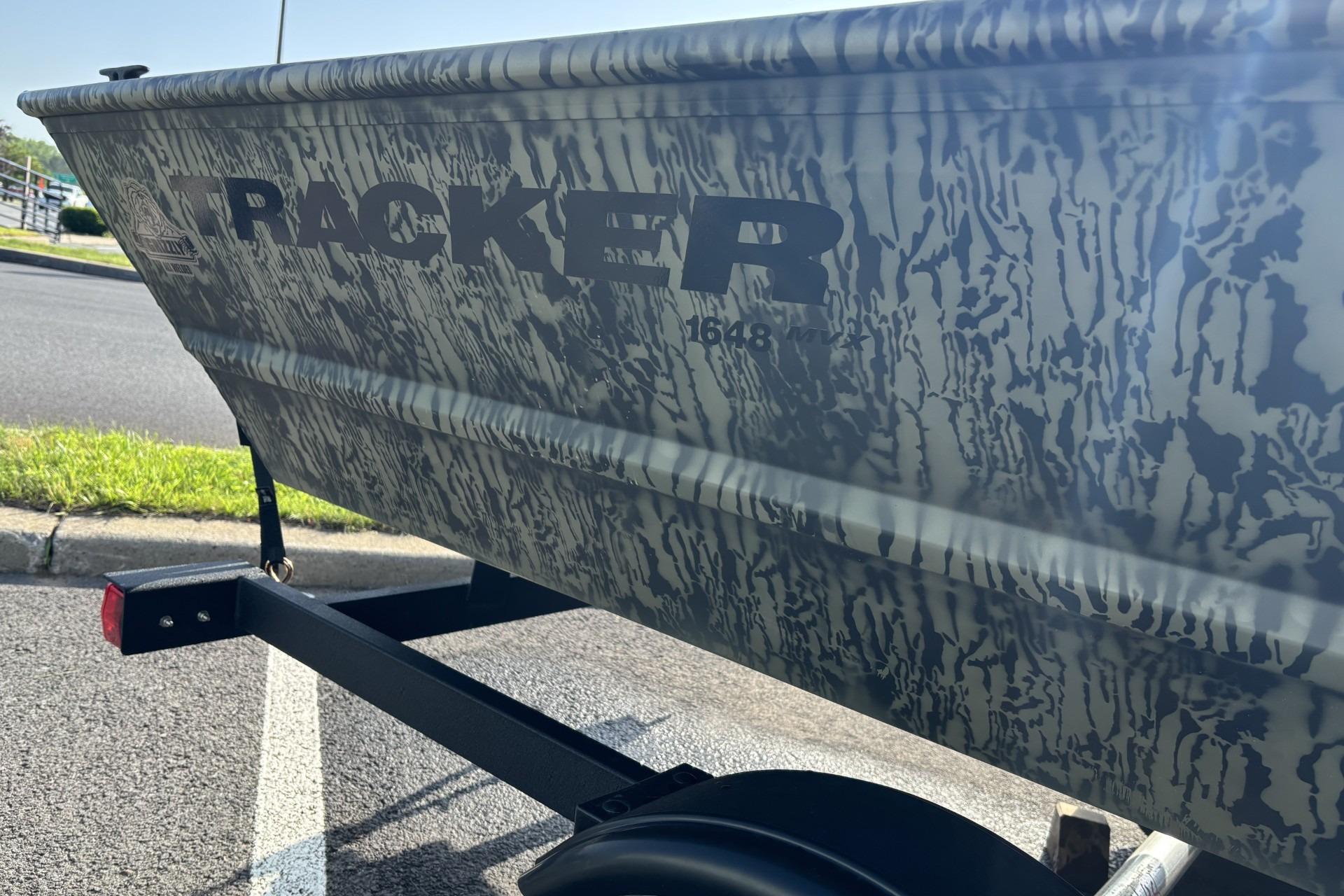 2026 Tracker Grizzly 1648 Utility boat with camouflage pattern on a trailer.