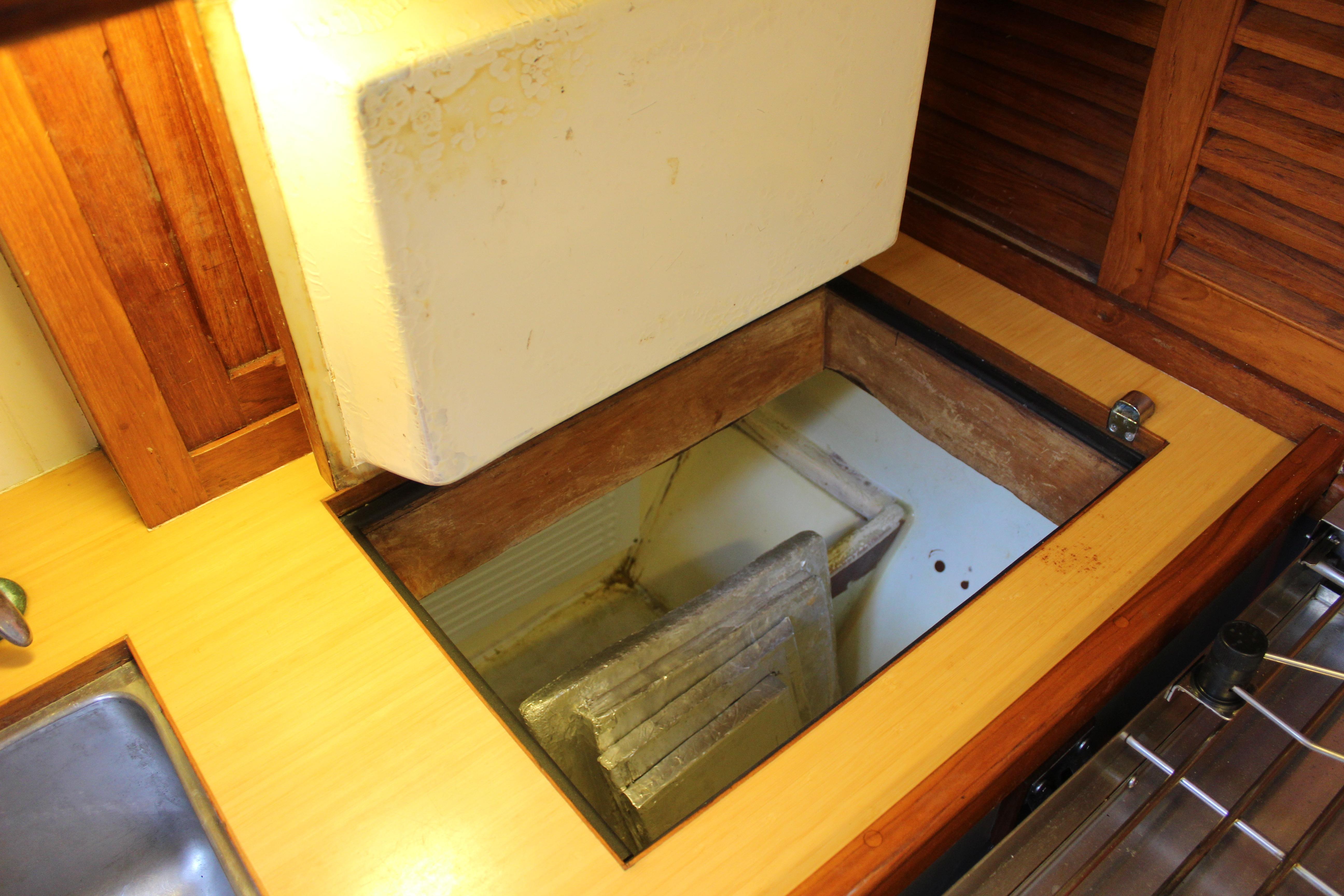 Wooden interior of 1981 Kelly Peterson 46 yacht, featuring an open storage compartment.