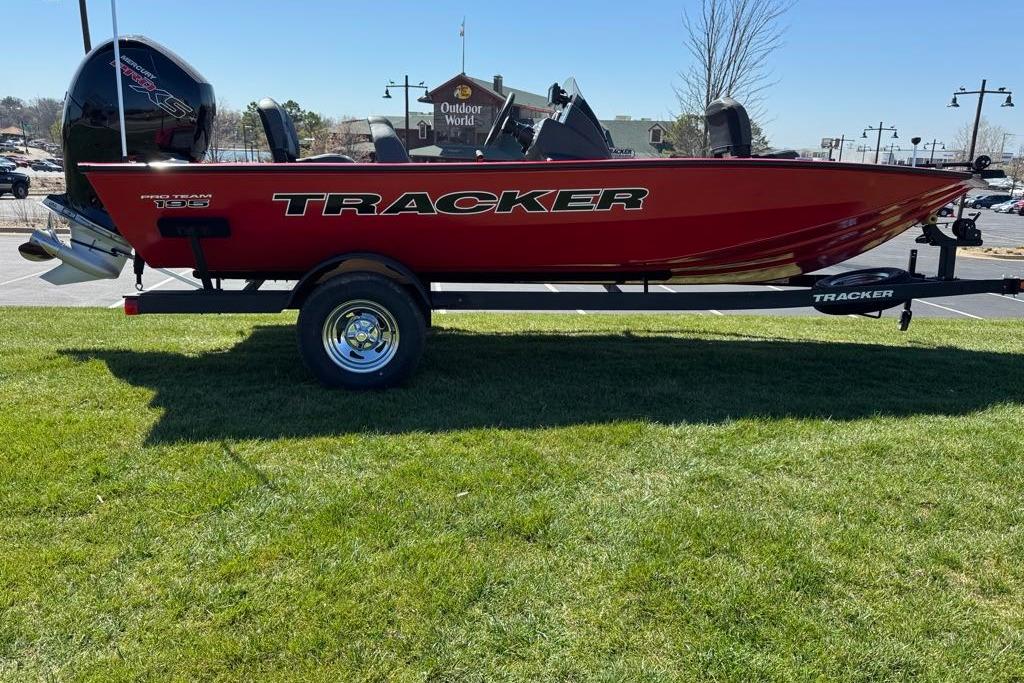 2026 Tracker Pro Team 195 boat on trailer, parked on grass, sunny day.