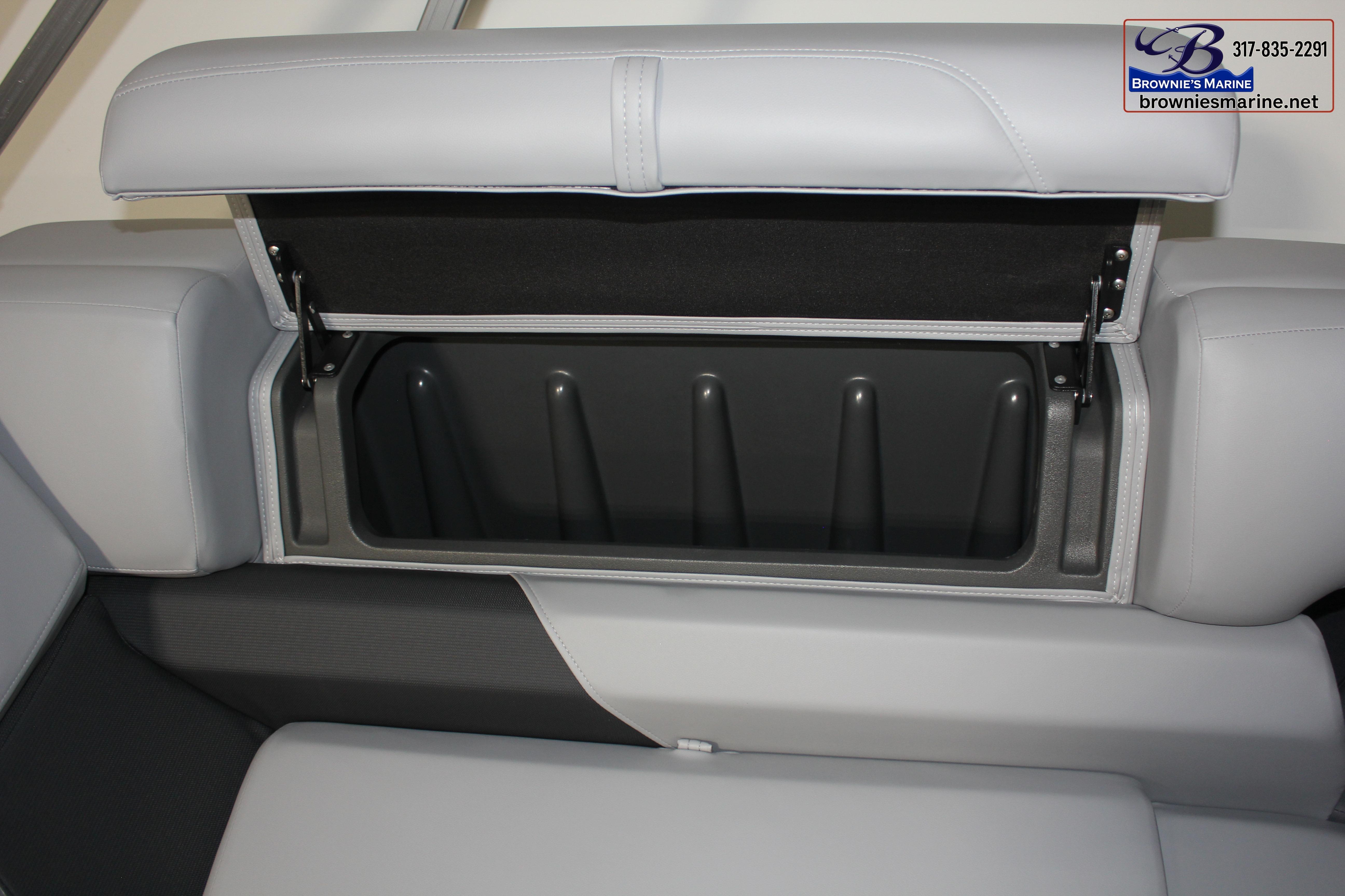 2026 Sun Tracker Party Barge 22 DLX storage compartment with open seat cushion.