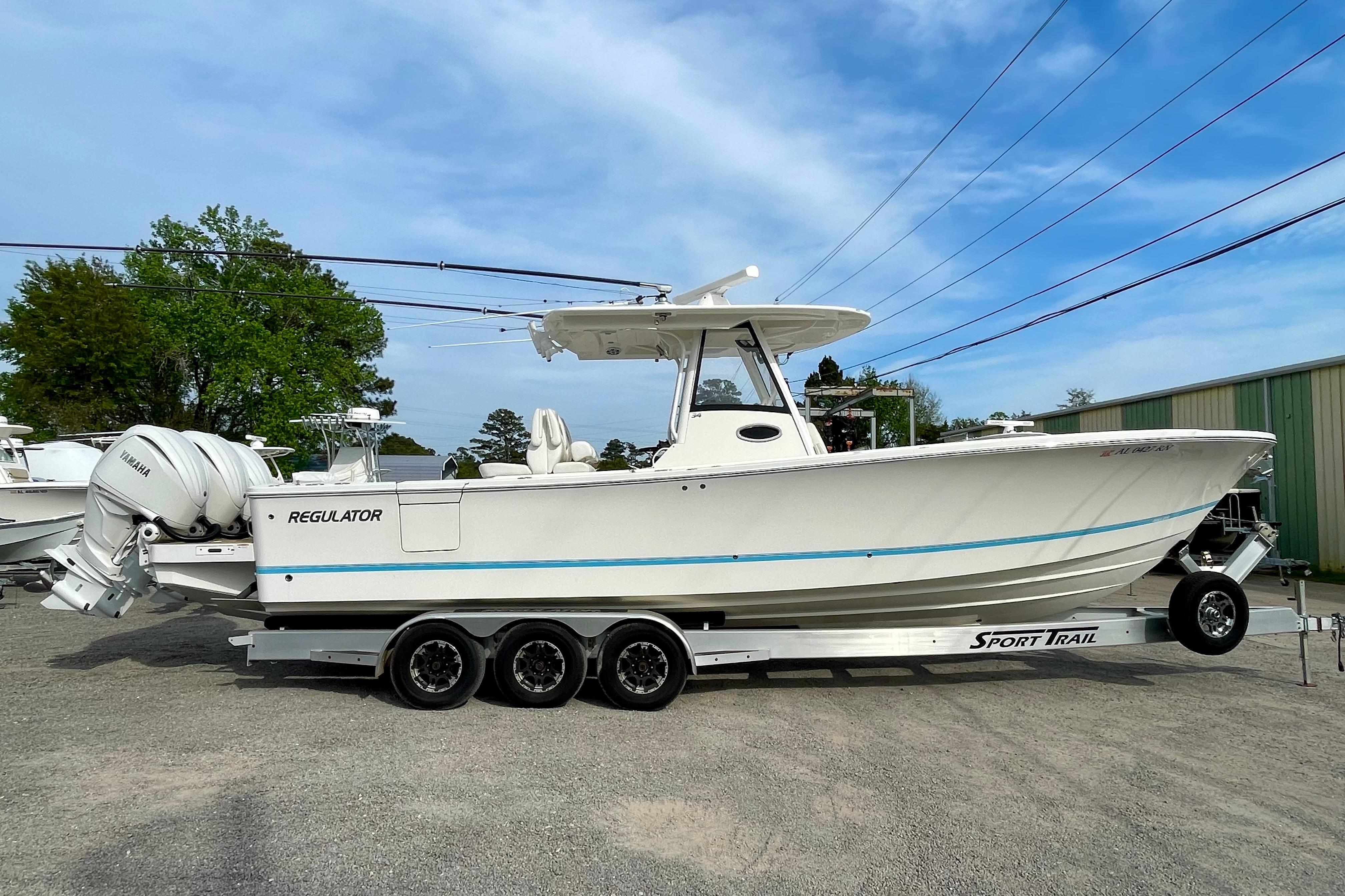 2023 Regulator 34 boat on a Sport Trail trailer, parked outdoors.