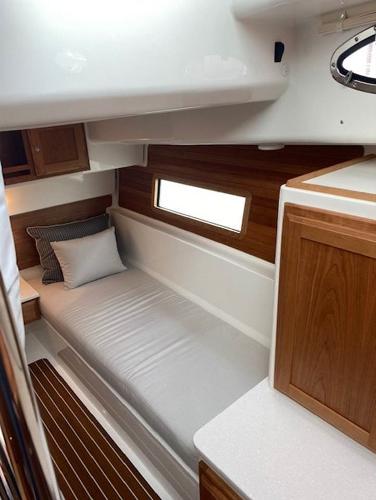 2025 Back Cove 39O cabin interior with wooden accents and a single bed.