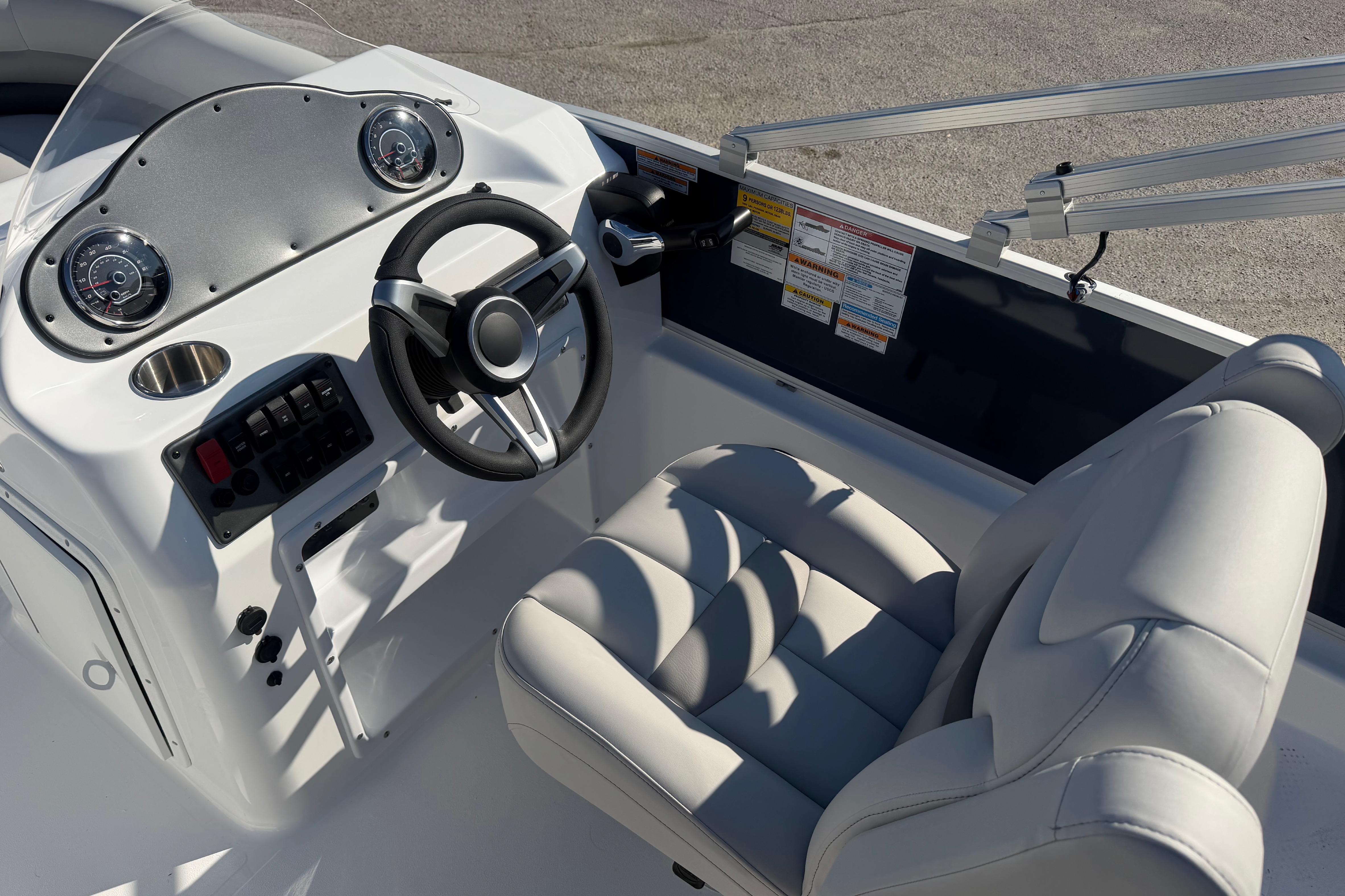 2026 Hurricane FunDeck 198 RE OB boat interior with steering wheel and gauges.