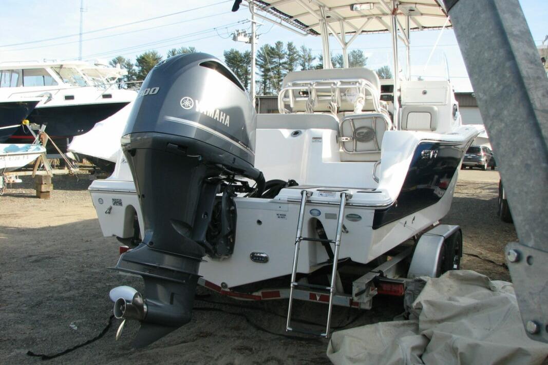 2020 Sea Fox 249 Avenger boat with Yamaha engine on trailer in marina setting.