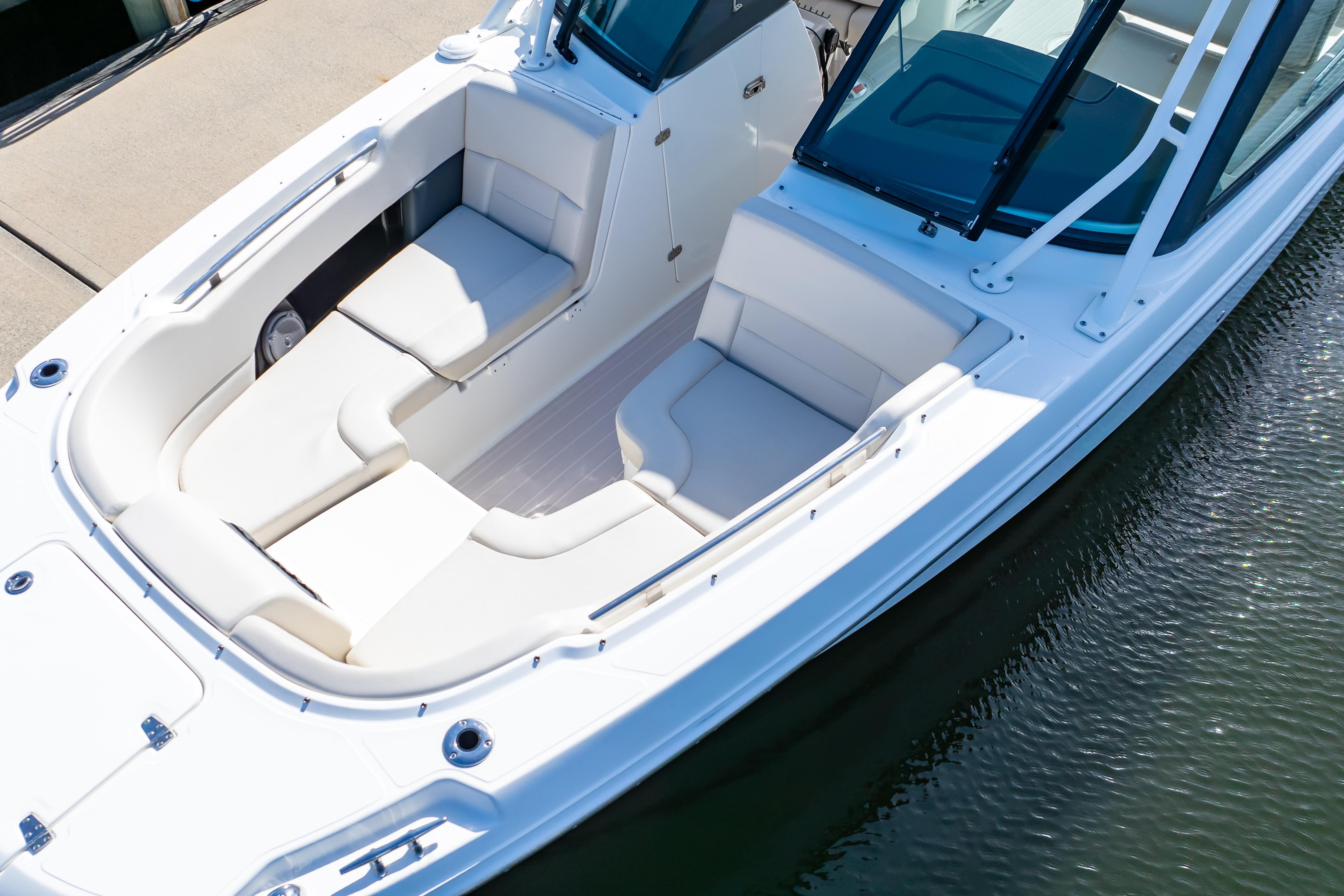 2019 Boston Whaler 270 Vantage boat with spacious seating, docked on calm water.