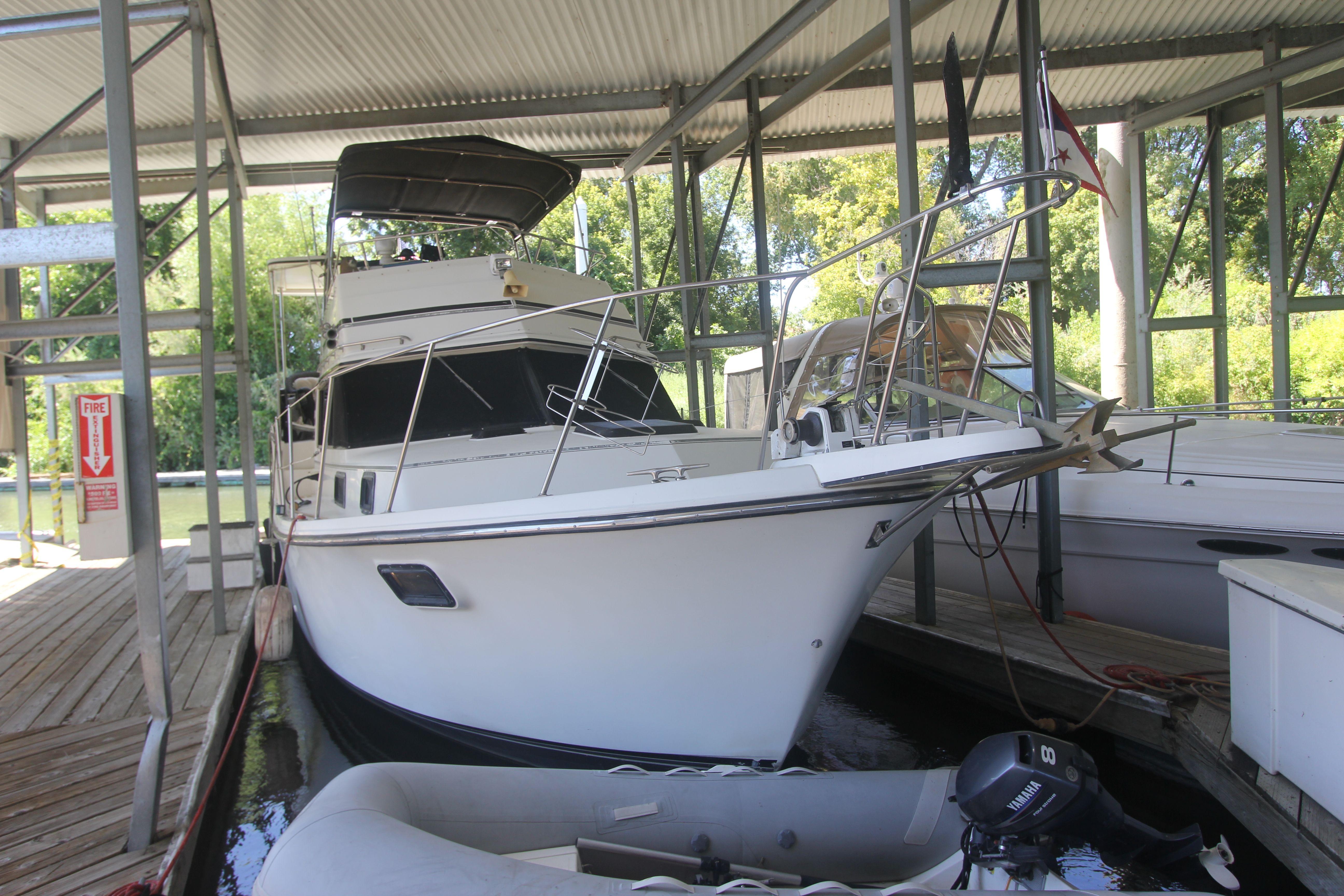 A 1988 Carver 3607 Aft Cabin Motor Yacht docked in a covered marina.