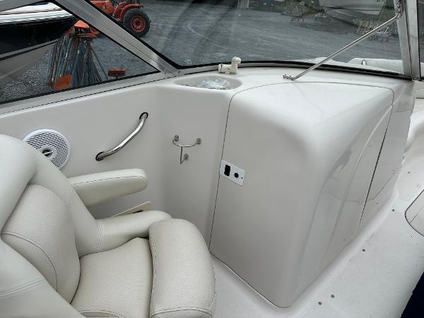 2004 Starcraft Aurora 2410 boat interior with white seating and control panel.