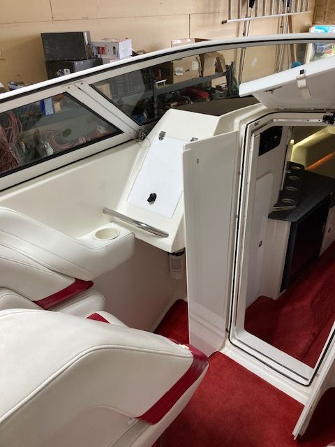 Interior of a 2001 Fountain Lightning boat with red carpeting.