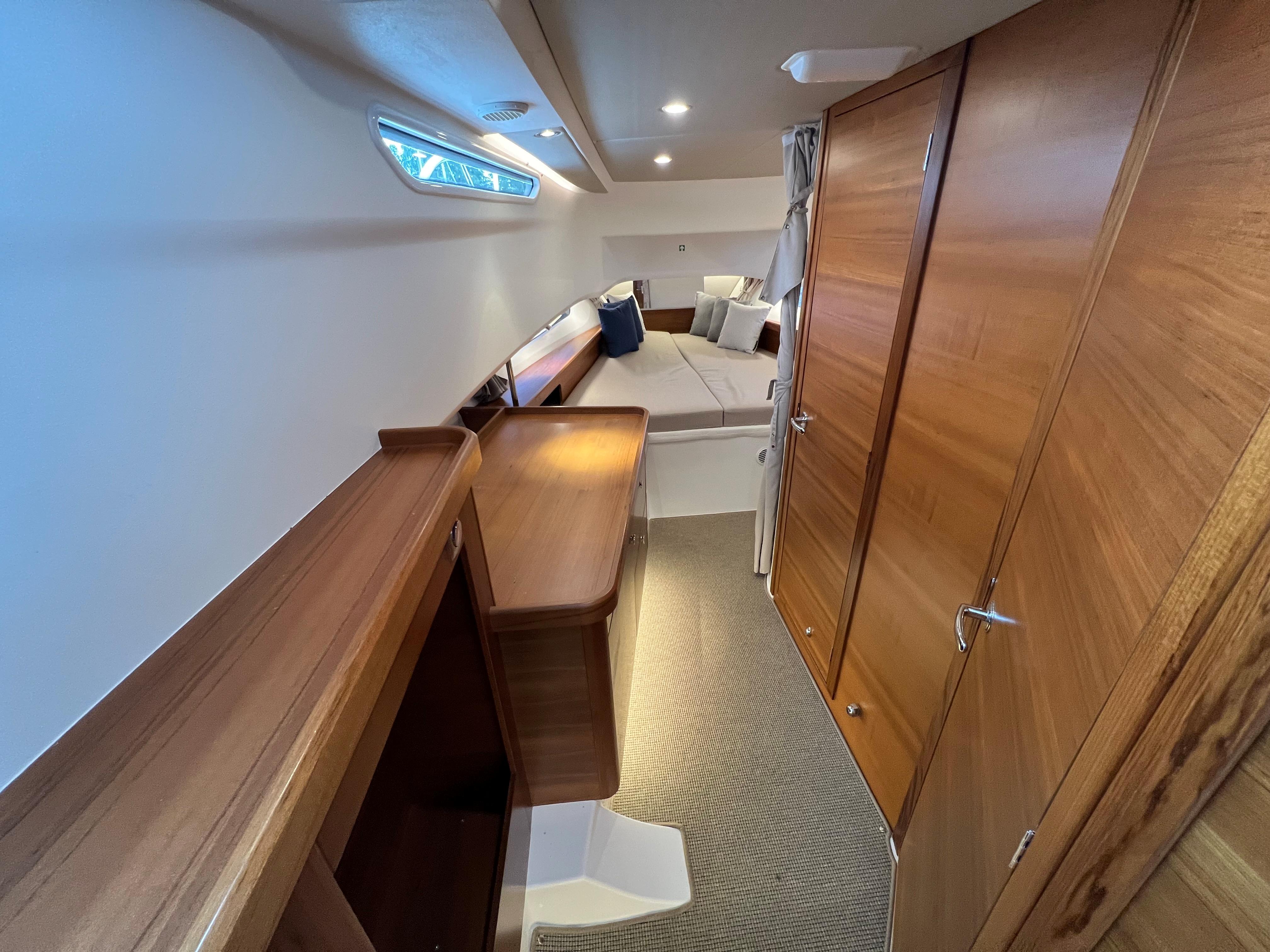 2021 Nimbus Tender 11 cabin interior with wooden finish and cozy seating area.