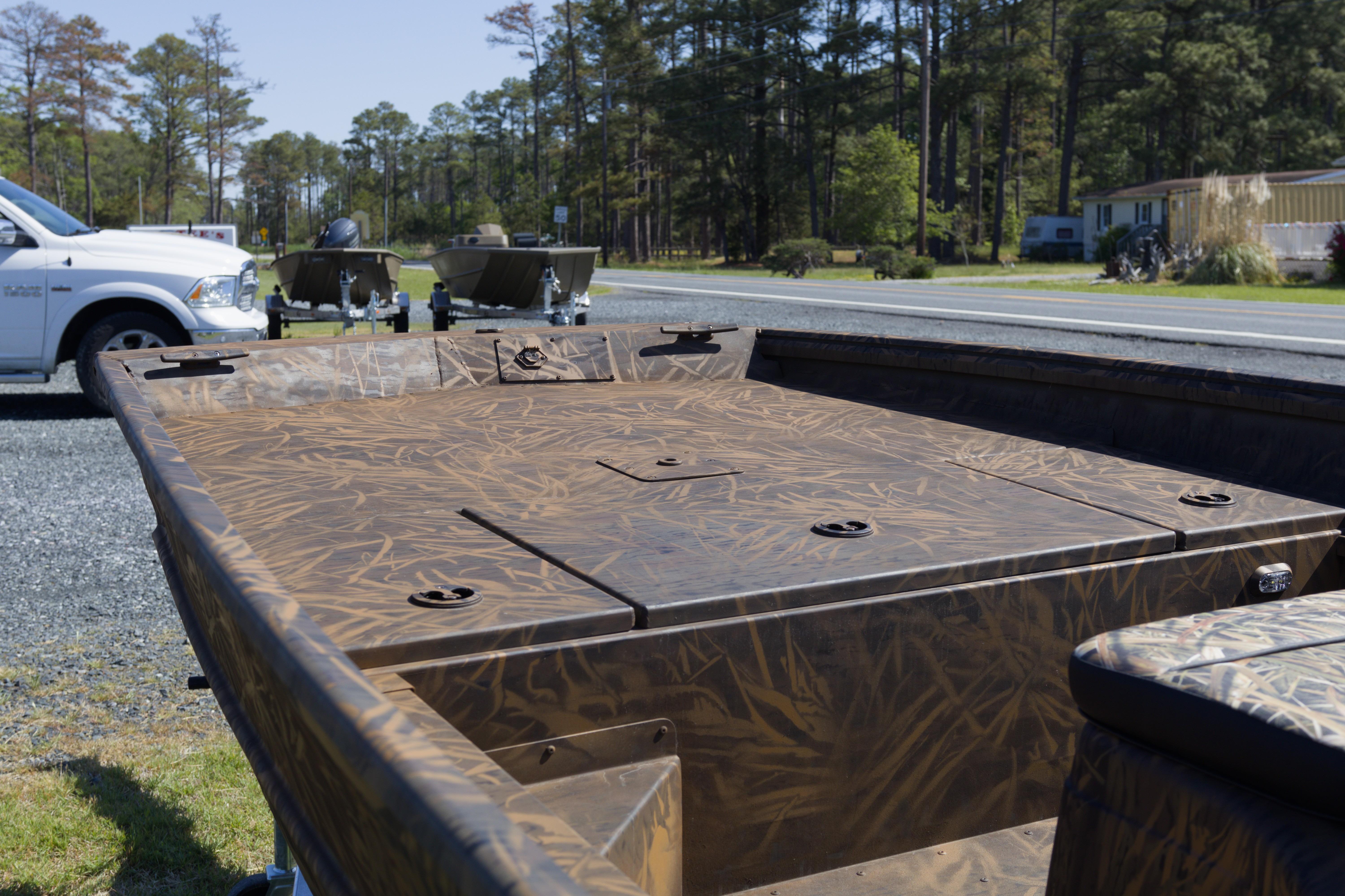 2026 G3 Gator Tough 17 CC boat with camouflage design, parked near a road.