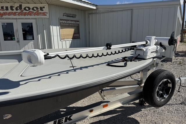 2025 Majek 24 Reaper boat on trailer outside a store, featuring advanced trolling motor.