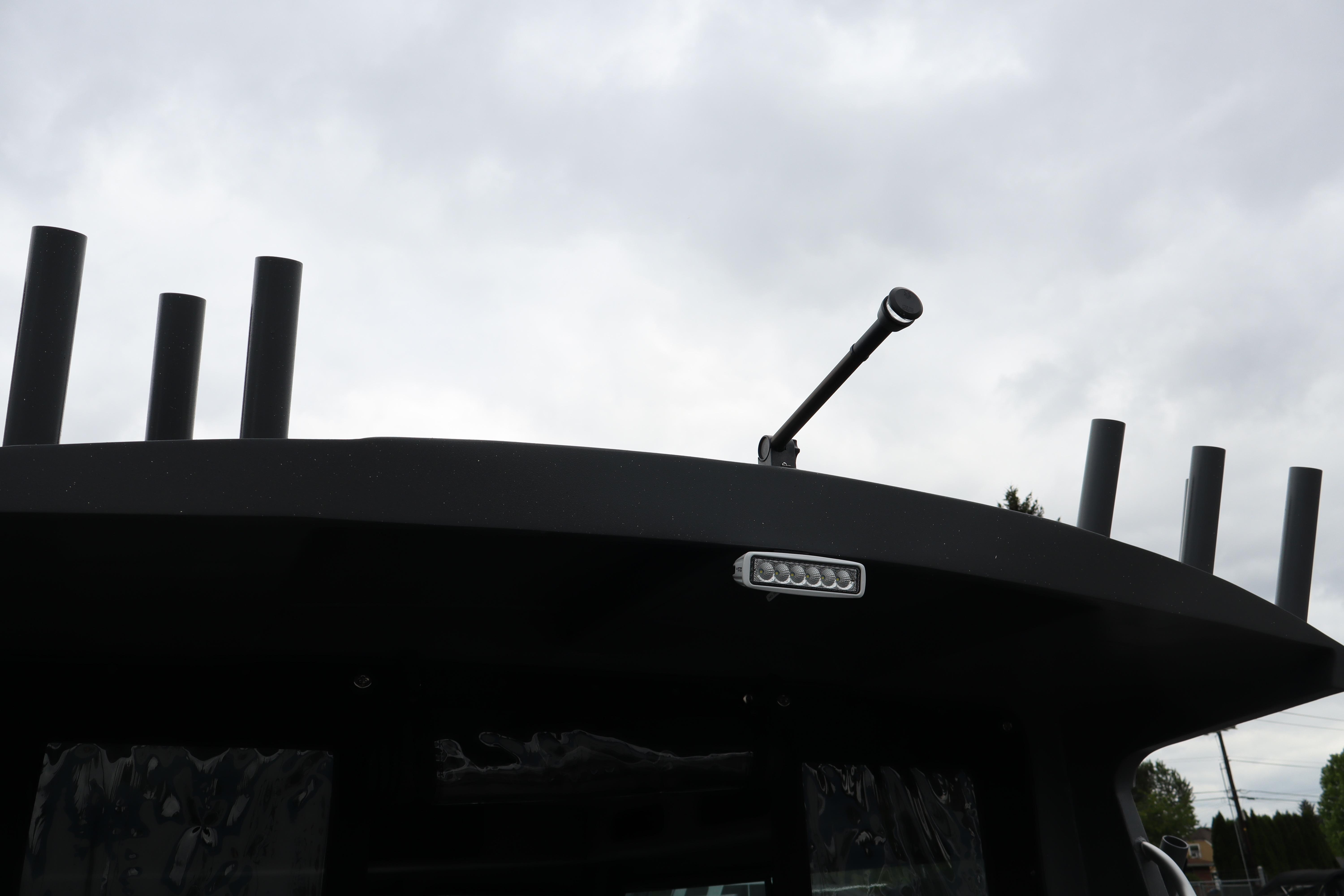 Rooftop view of 2026 Alumaweld Horizon 24 boat with rod holders and light.