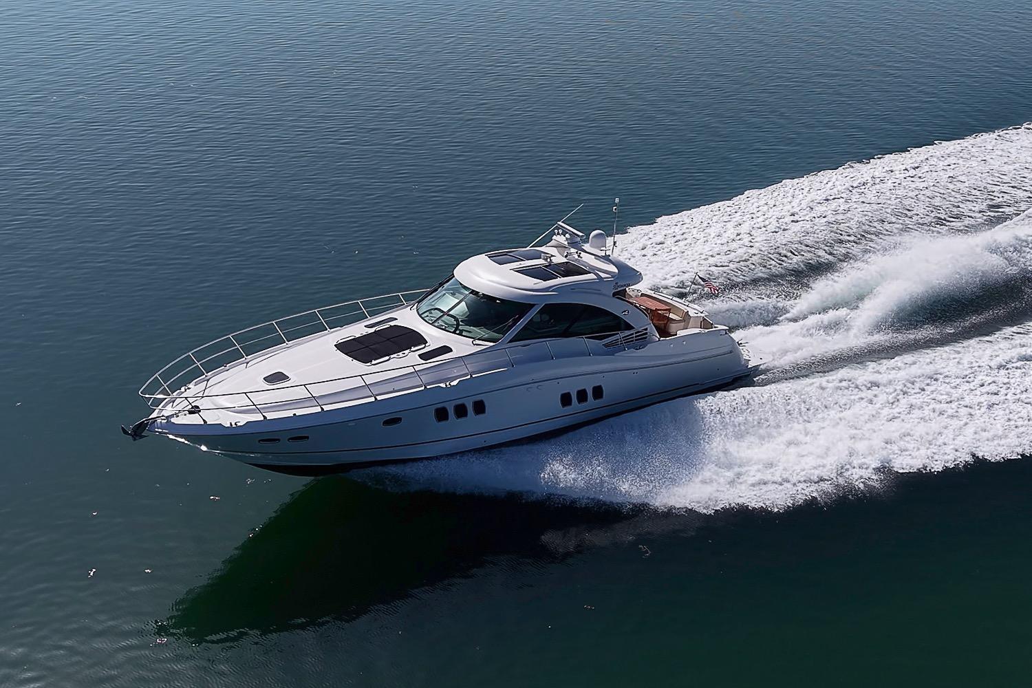 2008 Sea Ray 60 Sundancer yacht cruising on open water, creating a dynamic wake.