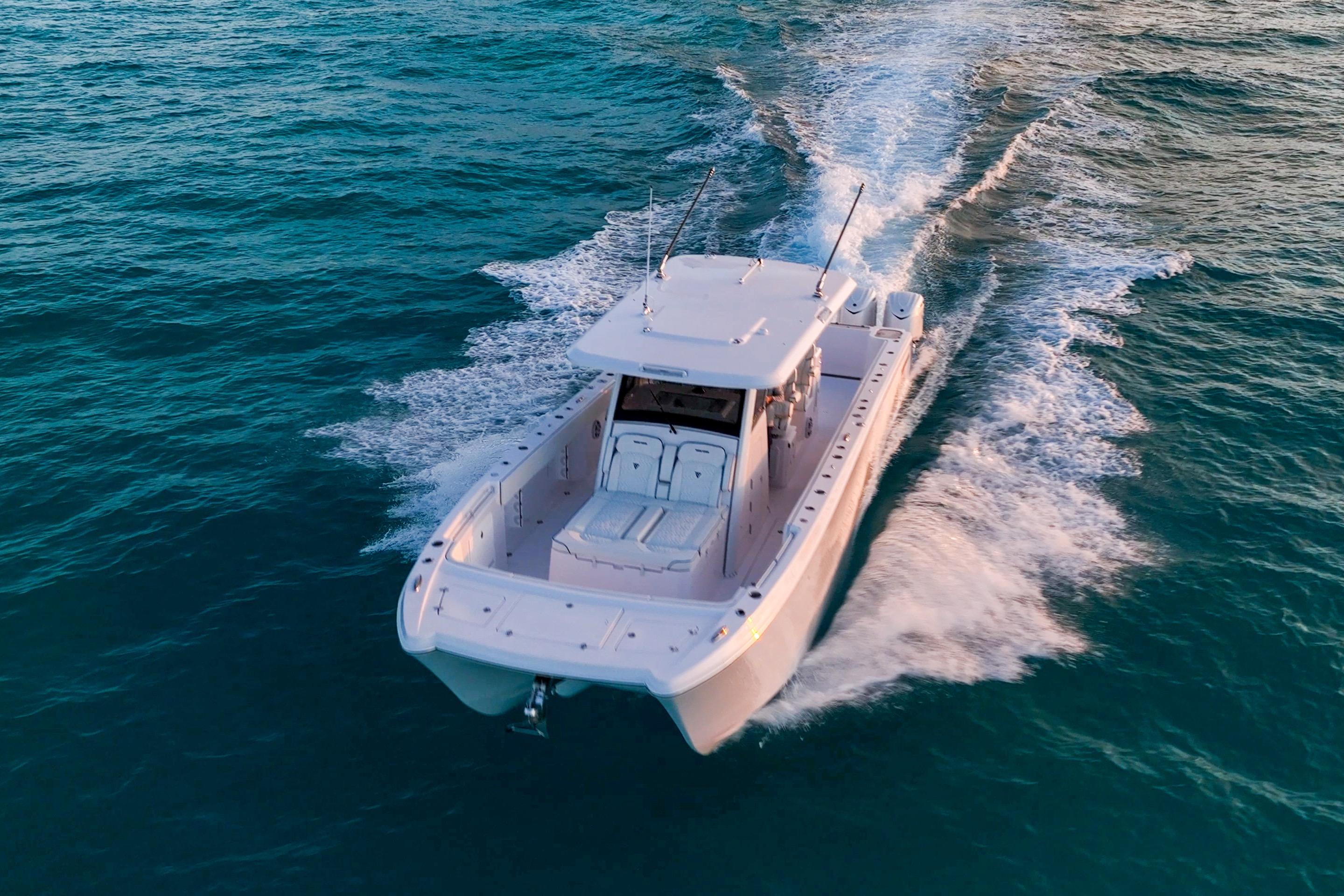 2026 Twin Vee 400 GFX2 CC cruising on open water, aerial view.