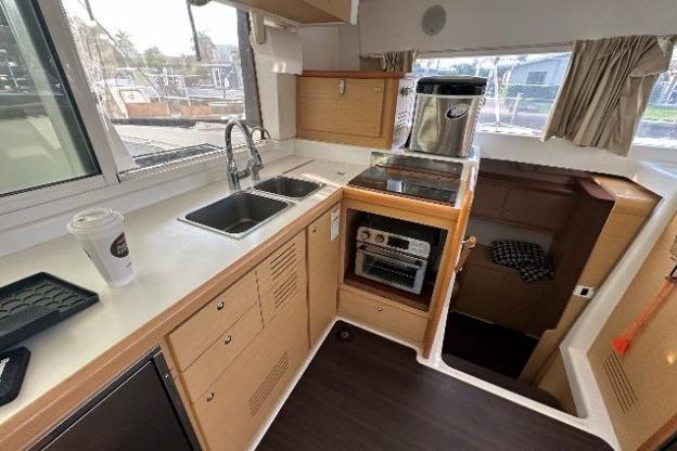 Modern kitchen interior of 2010 Lagoon 421 catamaran with dual sinks and appliances.