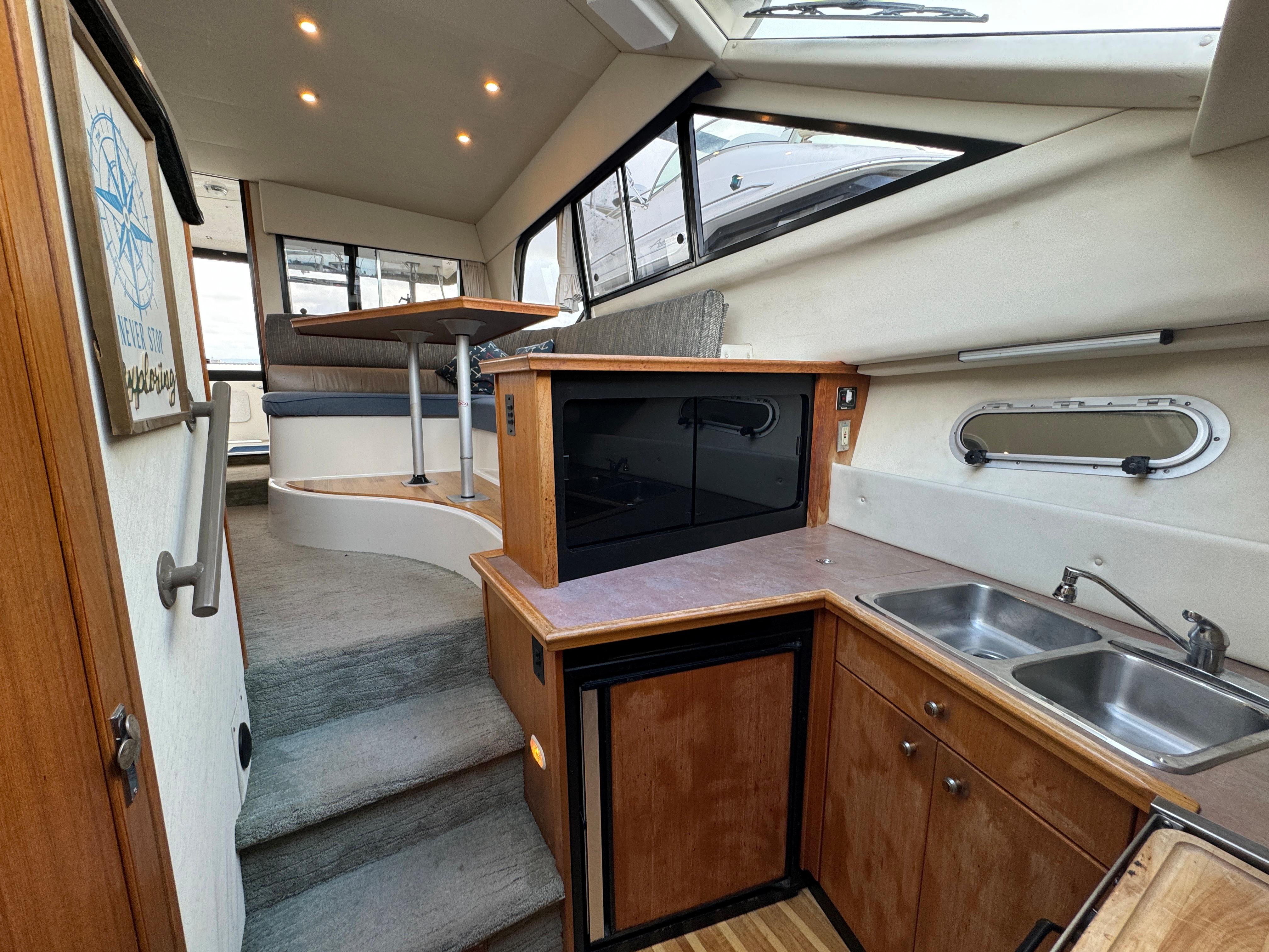 Interior of 1996 Bayliner 3388 Command Bridge Motoryacht with kitchen and dining area.