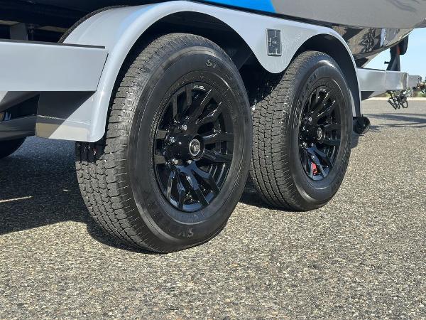 2025 Axis A225 trailer with black alloy wheels on asphalt surface.