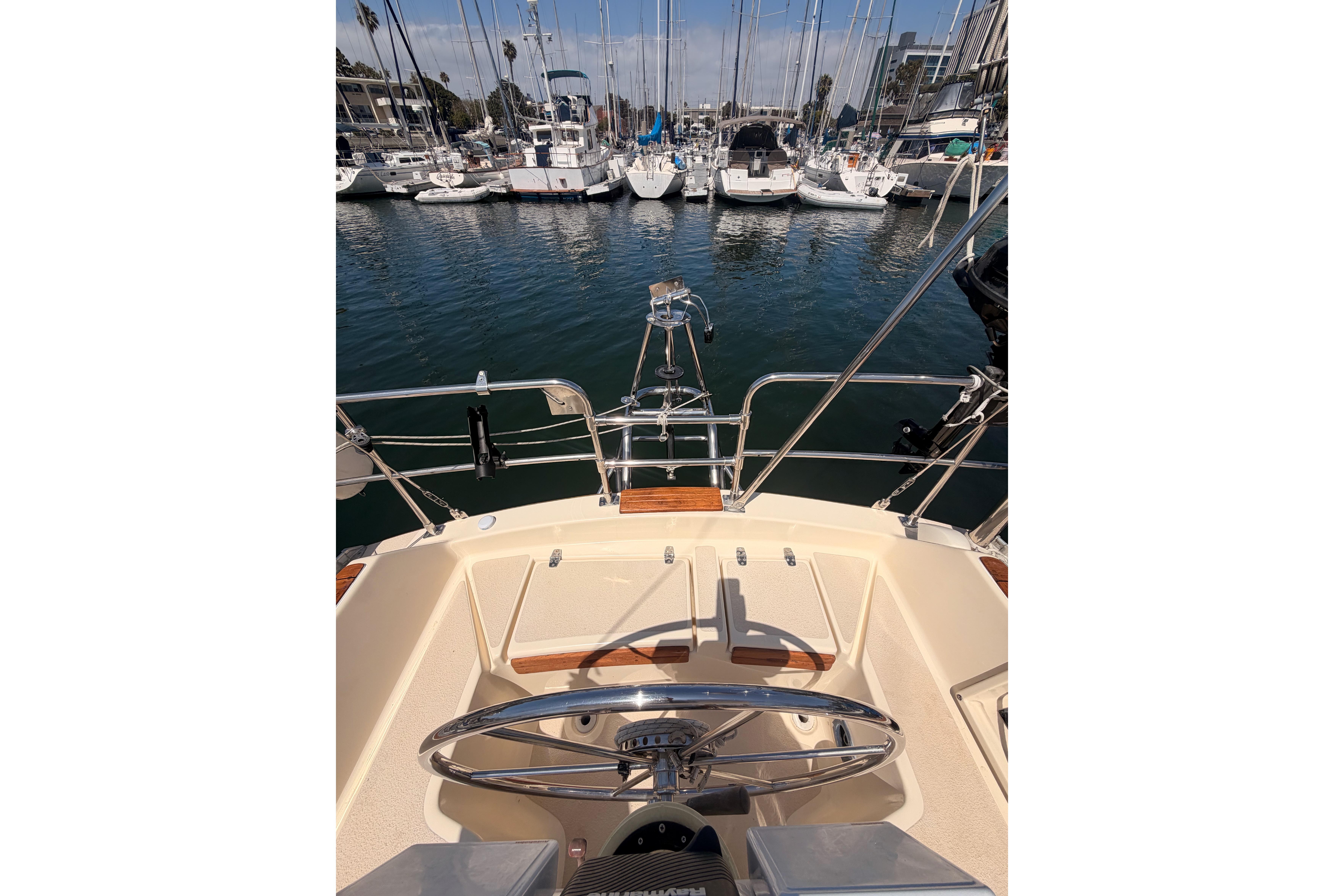 Cockpit view of 1991 Caliber 33 sailboat docked in a marina.