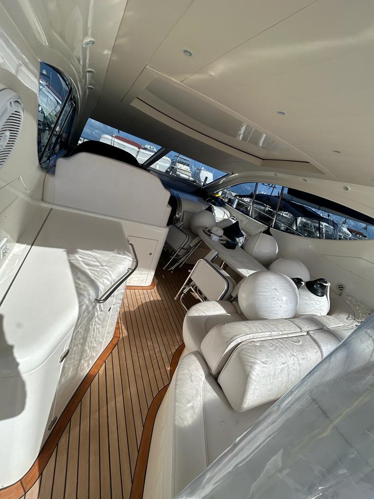 2007 Uniesse 54 Sport yacht interior with white leather seating and wooden flooring.