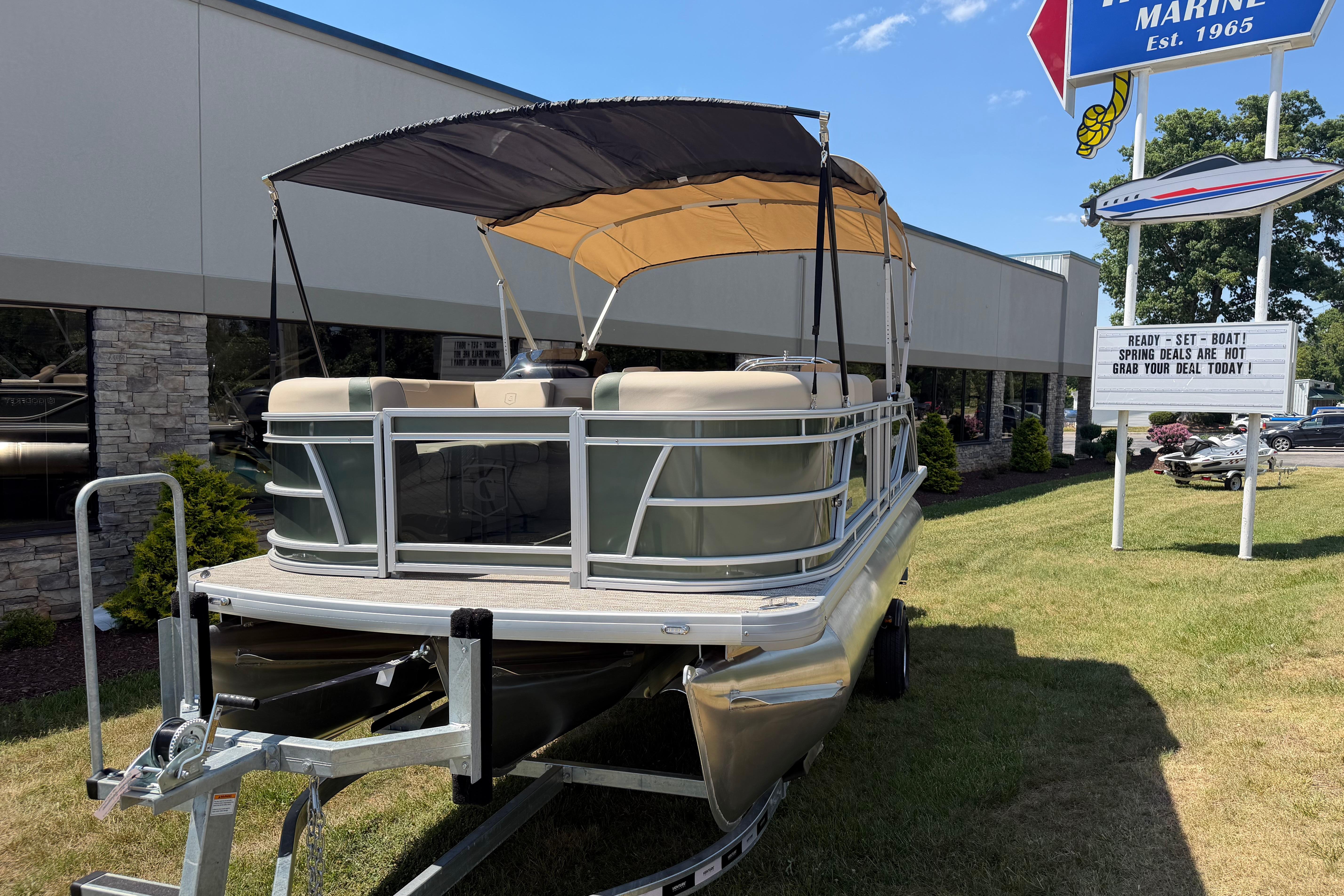 2026 Godfrey SW 2086 SBC pontoon boat on trailer outside marine dealership.