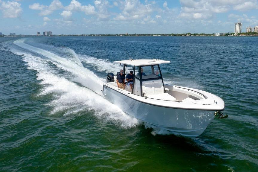 2027 Reef Runner 340 boat cruising on open water under a clear sky.