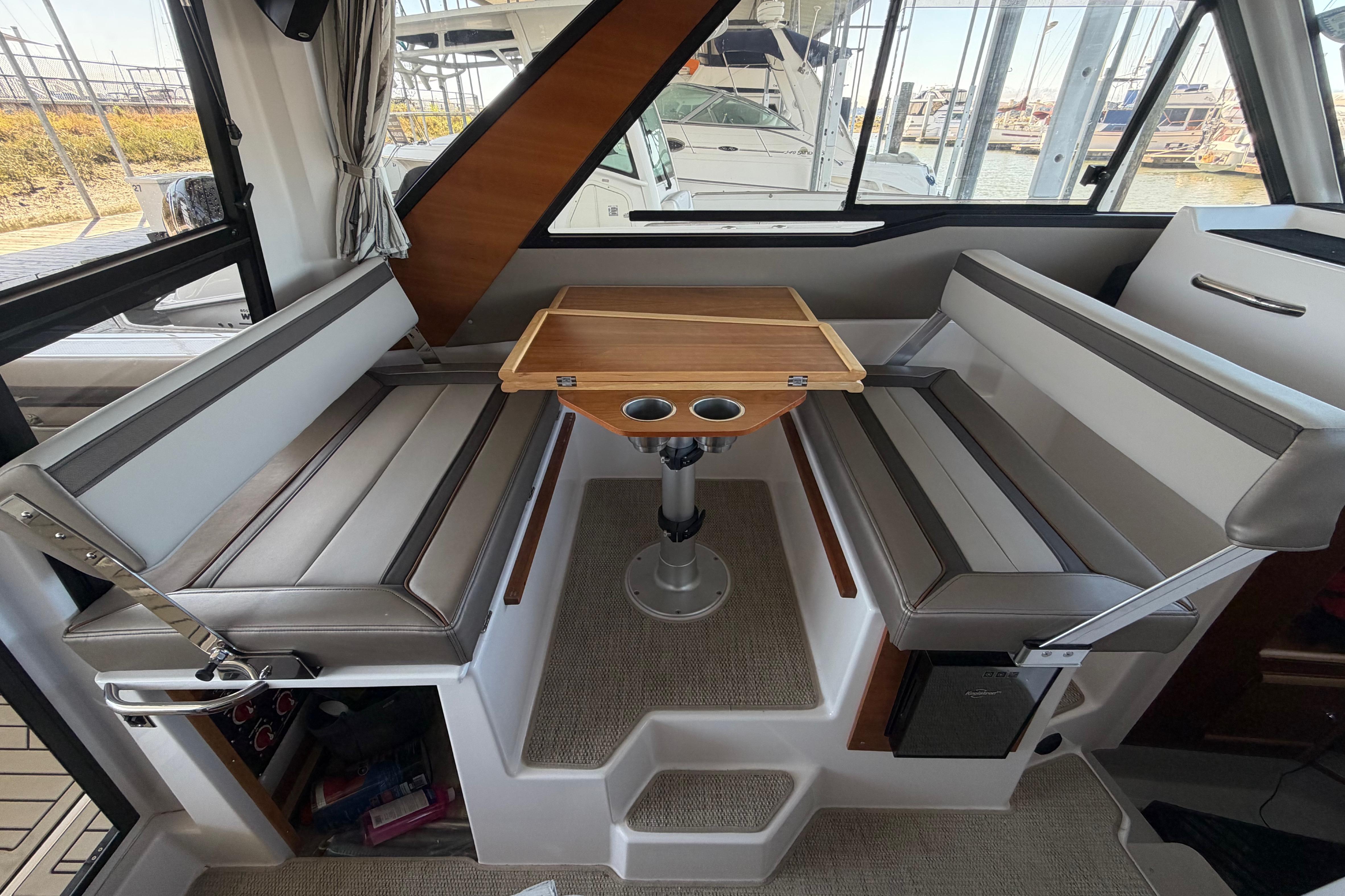 Interior of 2023 Cutwater C-288 Coupe featuring a cozy dining area with cushioned seating.