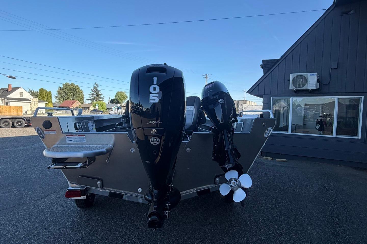 2026 Thunder Jet 209 Rush OT boat with dual outboard motors in a parking lot.