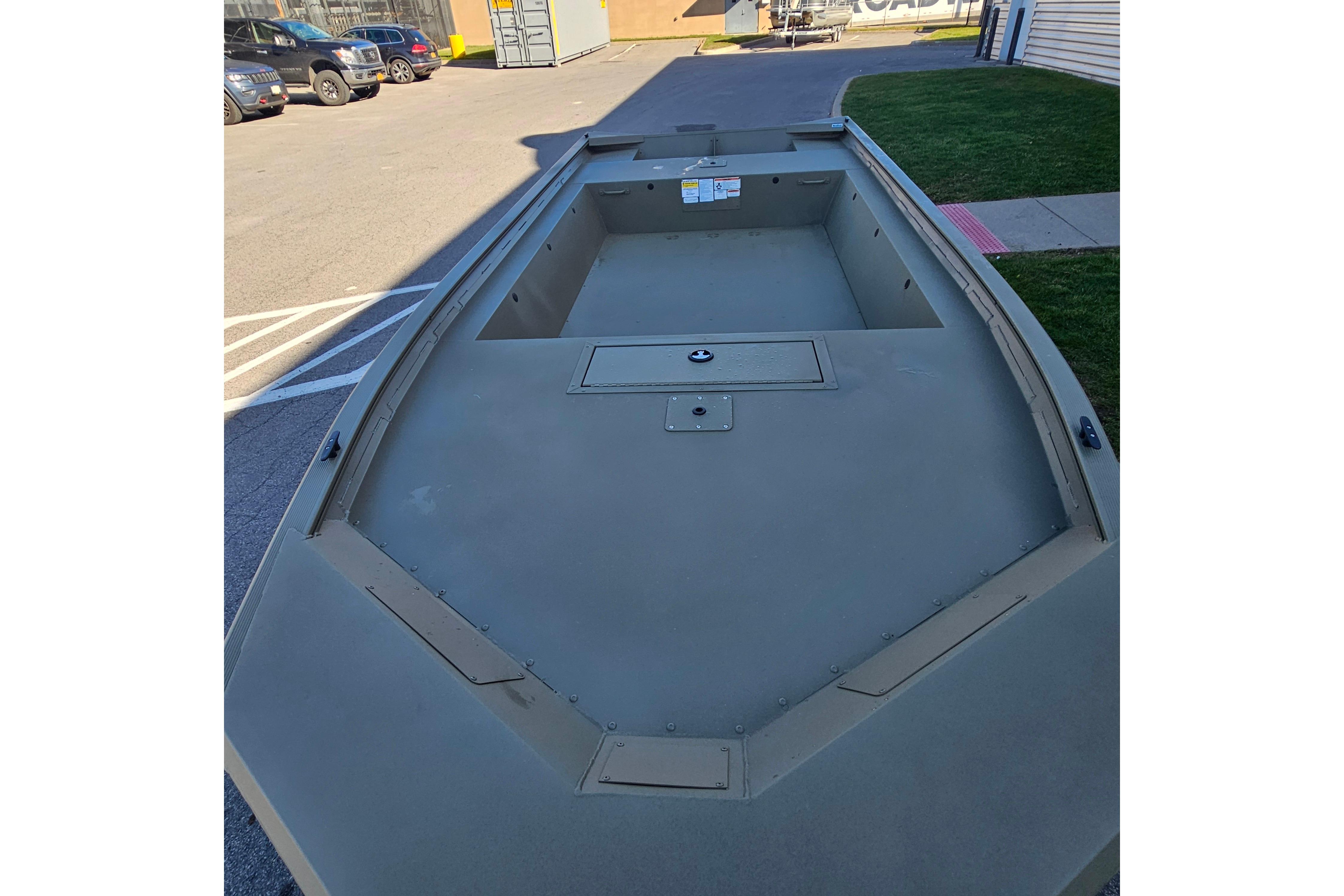 2026 Tracker Grizzly 1754 Utility boat, empty interior, parked outdoors.